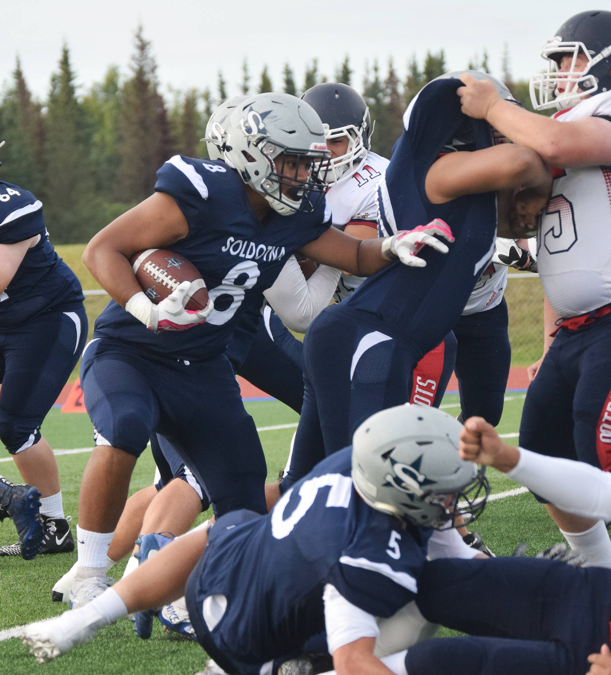 Soldotna junior Aaron Faletoi (8) bursts through the North Pole defense to gain some yards Friday at Soldotna’s Justin Maile Field. (Photo by Joey Klecka/Peninsula Clarion)
