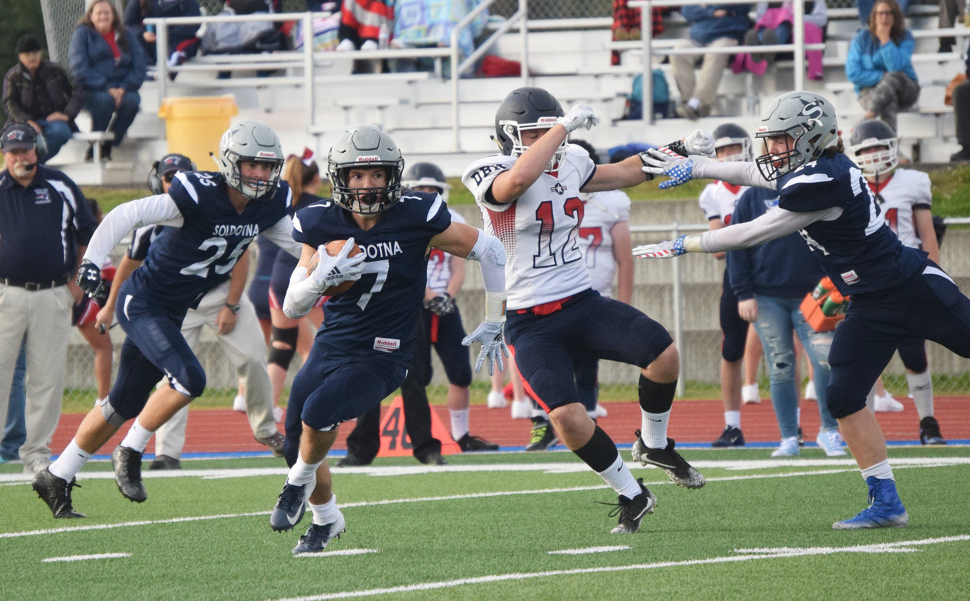 Soldotna junior Wyatt Medcoff (7) bursts through a hole after intercepting a pass Friday against North Pole at Soldotna’s Justin Maile Field. (Photo by Joey Klecka/Peninsula Clarion)