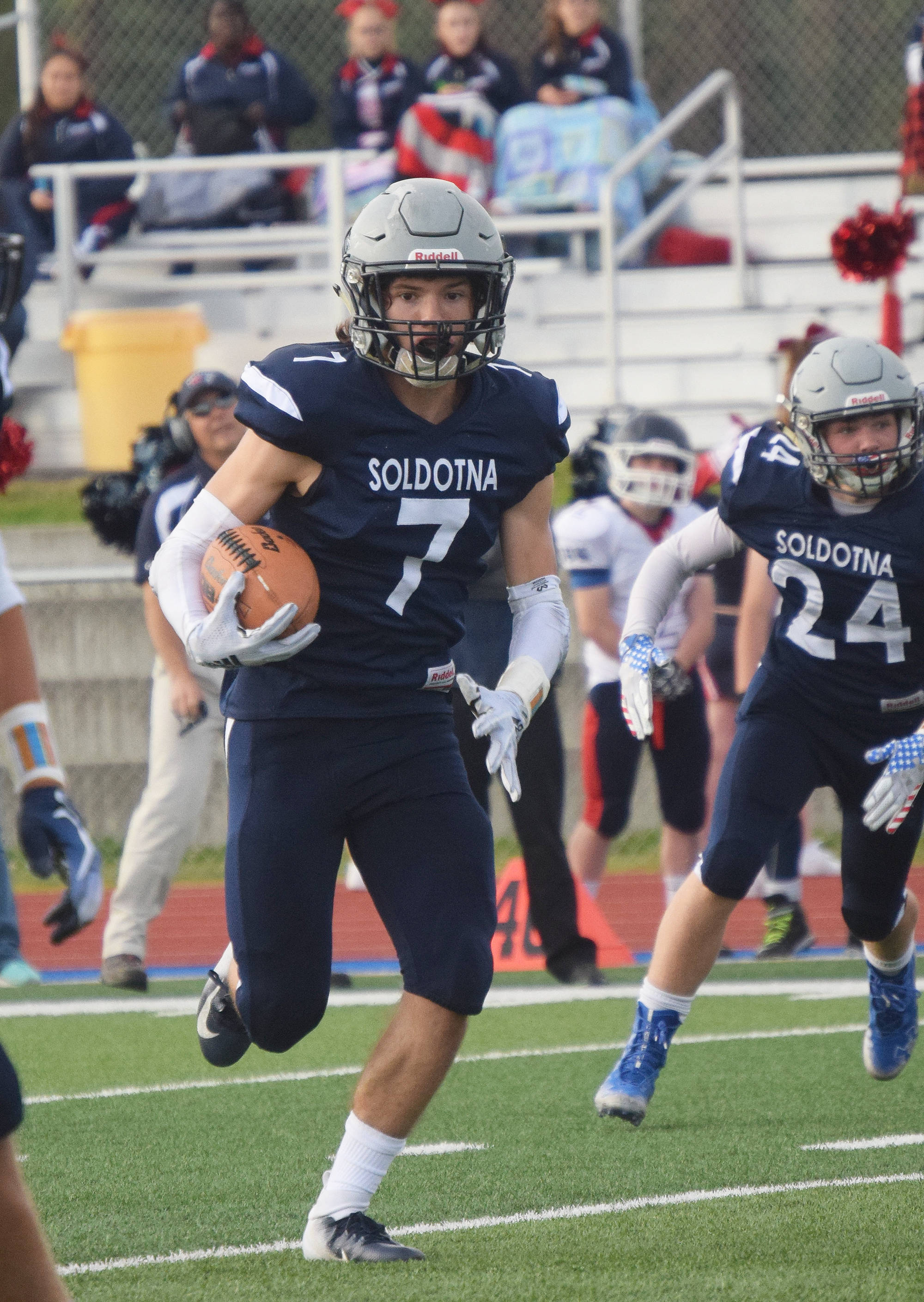 Soldotna junior Wyatt Medcoff looks for room to run after grabbing an interception Friday against North Pole at Soldotna’s Justin Maile Field. (Photo by Joey Klecka/Peninsula Clarion)