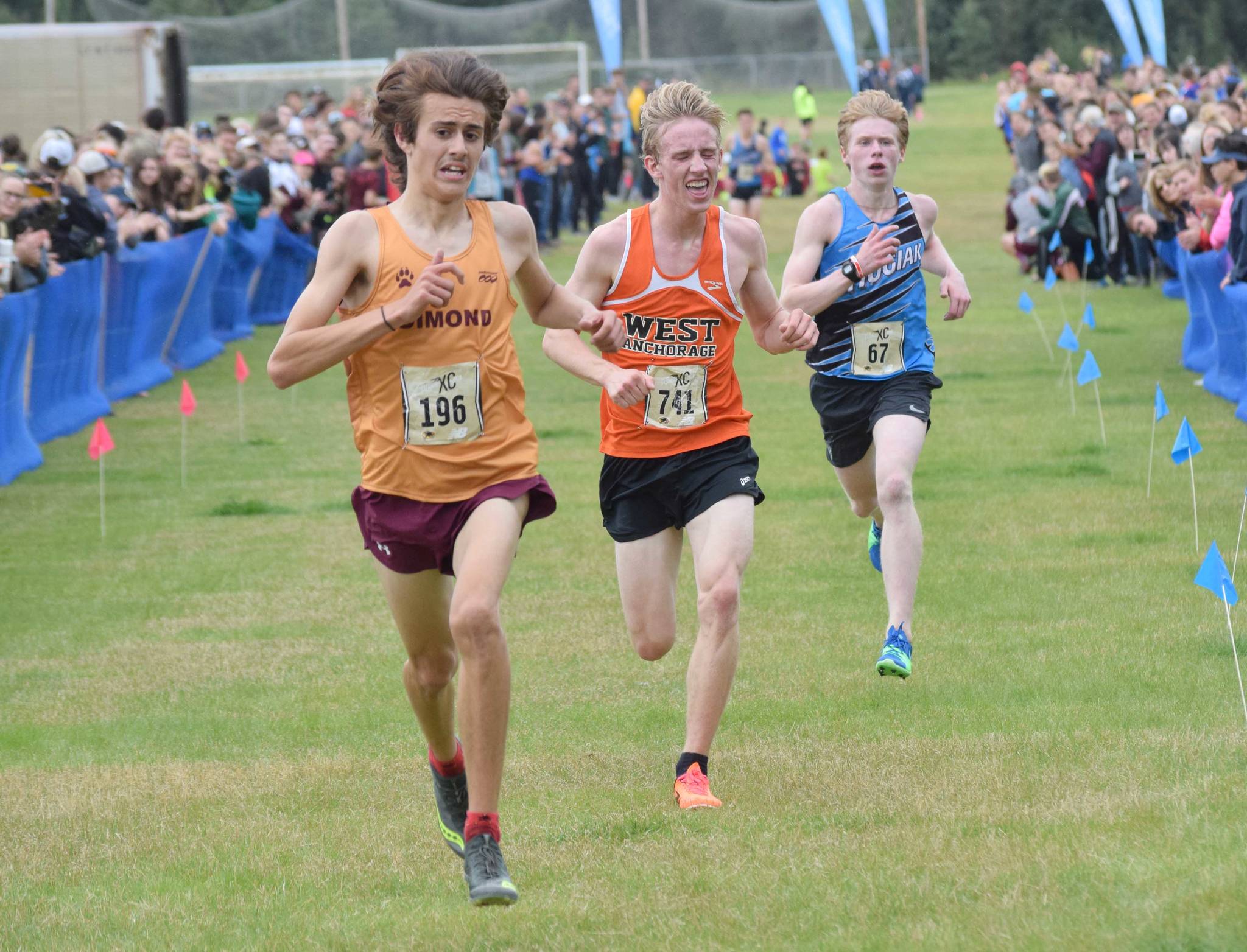 Dimond’s Santiago Prosser out-sprints West’s Everett Cason and Chugiak’s Daniel Bausch for the Tsalteshi Invitational title Saturday, Aug. 18, 2018, at Tsalteshi Trails. (Photo by Jeff Helminak/Peninsula Clarion)