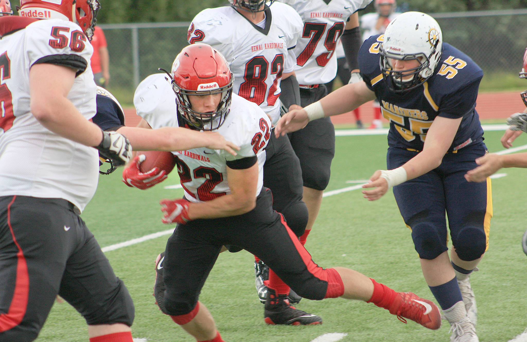 Kenai Central running back Titus Riddall avoids River Mann en route to another long gain Friday, Aug. 17, 2018, at Homer High School. (Photo courtesy of Clark Fair)