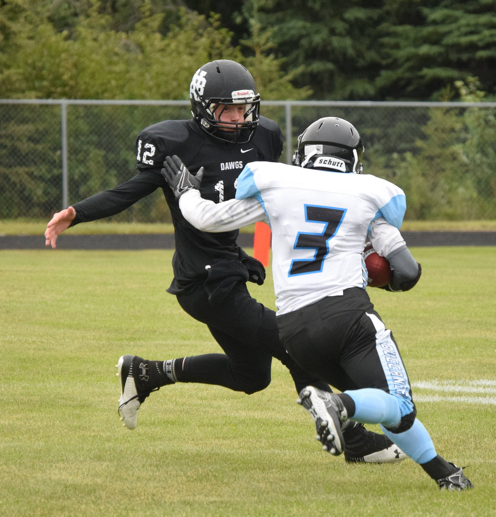 Nikiski junior Noah Litke attempts to tackle Valdez back Owen Chadwick (3) Saturday at Nikiski High School. (Photo by Joey Klecka/Peninsula Clarion)