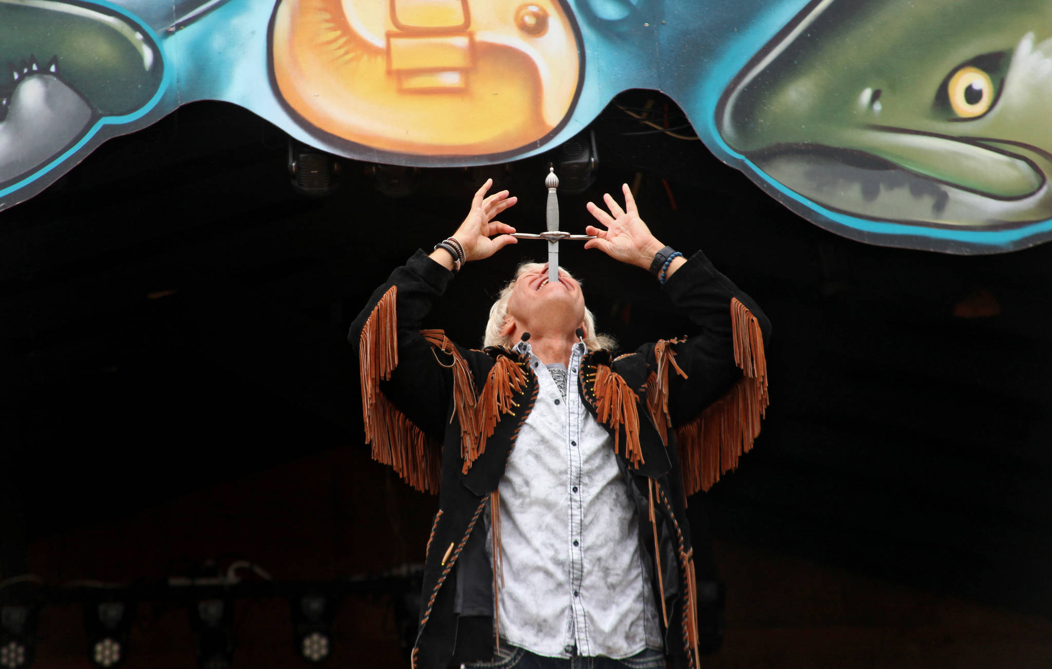 Sword swallower Dan Meyer demonstrates the technique during a show at the Kenai Peninsula Fair on Saturday, August 18, 2018 in Ninilchik, Alaska. (Photo courtesy Ben Boettger)