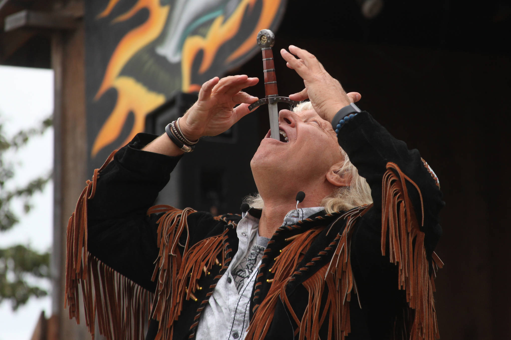 Sword swallower Dan Meyer demonstrates the technique during a show at the Kenai Peninsula Fair on Saturday, August 18, 2018 in Ninilchik, Alaska. (Photo courtesy Ben Boettger)