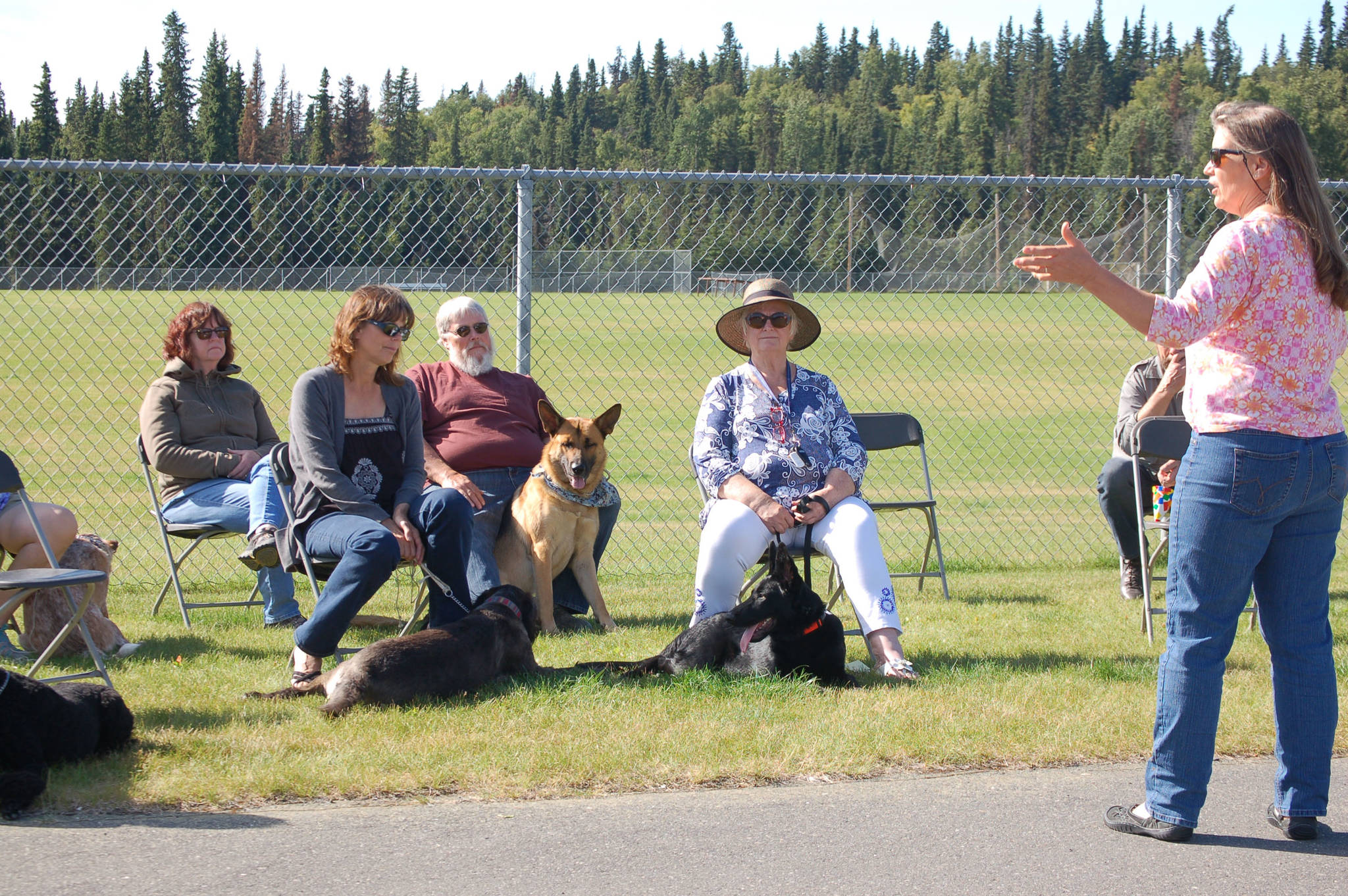 Scotch Pines Dog Training teacher Stephanie Hostetter, right, addresses dogs and people ahead of a graduation ceremony for the obedience-training class on Wednesday, Aug. 22, 2018, in Soldotna, Alaska. (Photo by Erin Thompson/Peninsula Clarion)