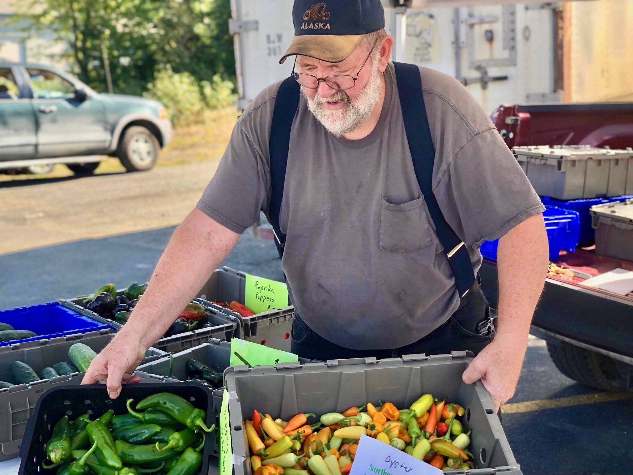 Dan Bilyeu of Northern Lights Mushrooms sells oyster mushrooms and a large variety of peppers, including scotch bonnets, jalapenos, poblanos and more at the Tuesday, Aug. 28, 2018 Farmers Fresh Market at the Kenai Peninsula Food Bank, near Soldotna, Alaska. (Photo by Victoria Petersen/Peninsula Clarion)