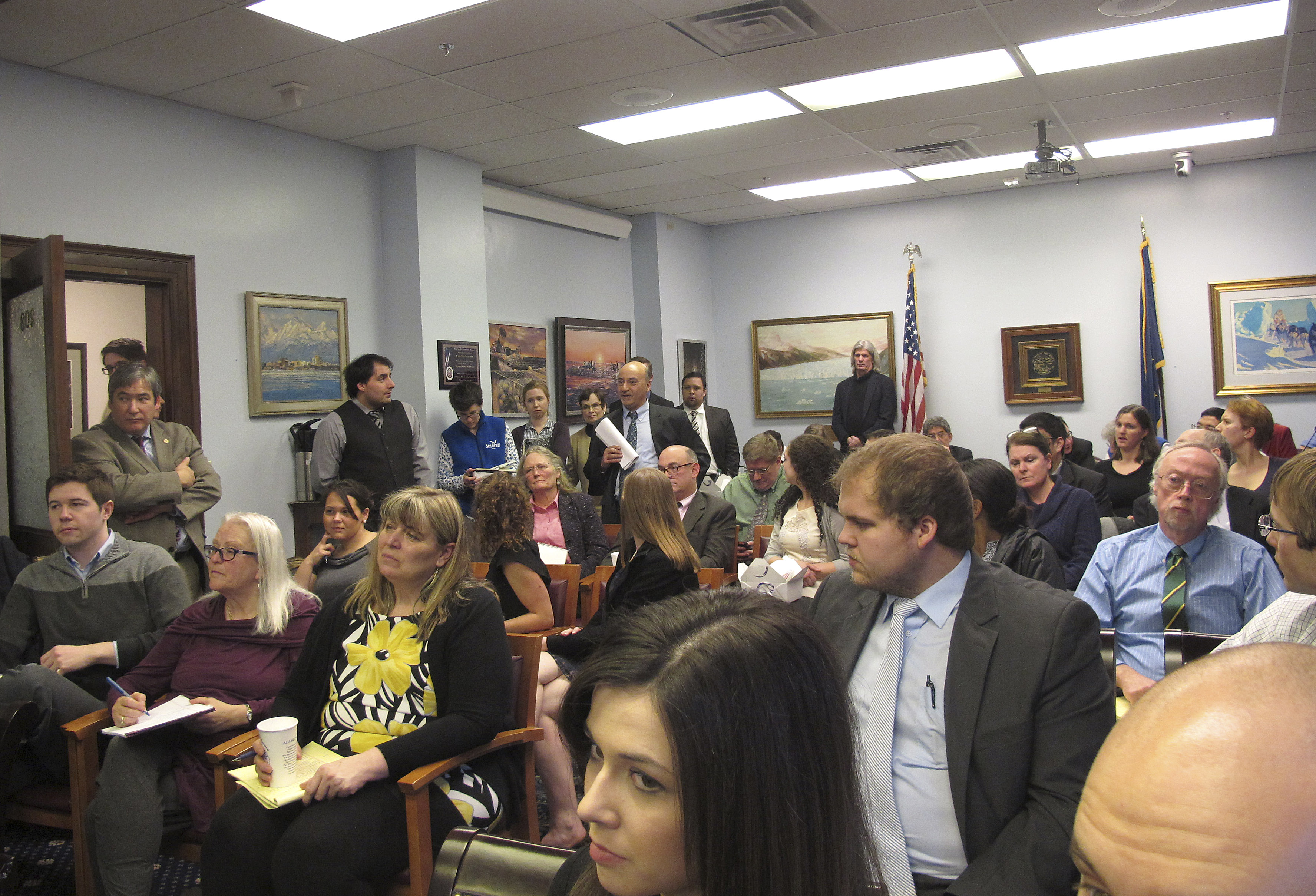 In this March 4, 2015 photo, a large audience assembles at the state Capitol to hear a Lunch and Learn presentation on Medicaid expansion, including state legislators, aides and others, in Juneau, Alaska.