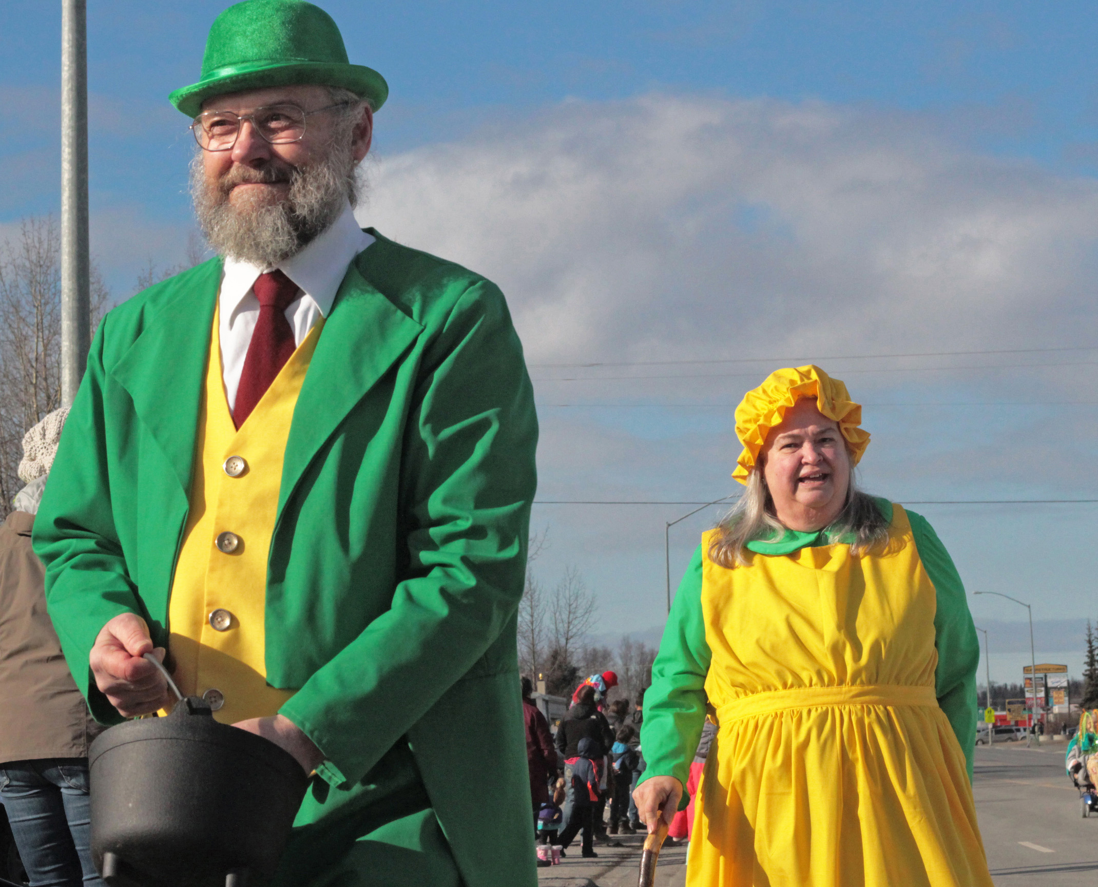 Tom (left) and Sonja Redmond distribute smiles and green pepermints during the Soldotna St. Patrick's Day parade on Thursday, March 17 in Soldotna. Sonja Redmond said the couple have marched in the parade almost every year since it began 25 years ago. Their grandchildren, Anna and Sara DeVolld, have joined them since Anna was "just old enough to sit up in a wagon," Sonja said. Asked why they had first joined the parade, Sonja said "I don't remember — seems like we always have."