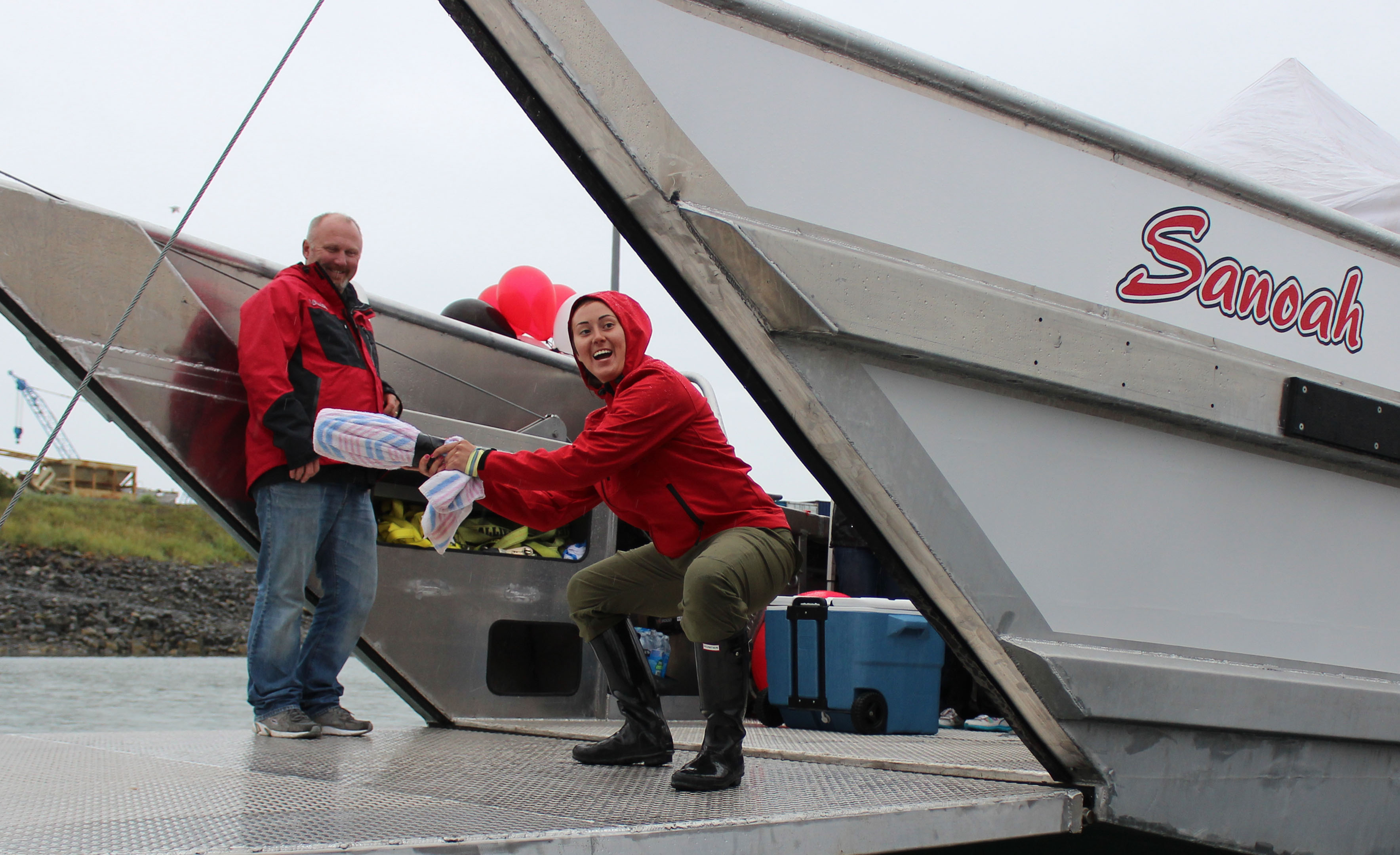 Steve Attleson and Natasha Huestis christen the Sanoah, a 56-foot landing craft, Sunday in Homer. The Sanoah was named for Huestis' 4-month-old daughter who died in a mudslide near Oso, Washington on March 22.