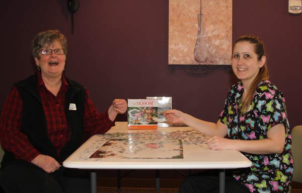Charis Place Administrator Colleen McNulty & caregiver Valerie Smith find the missing piece as they share life with their clients.