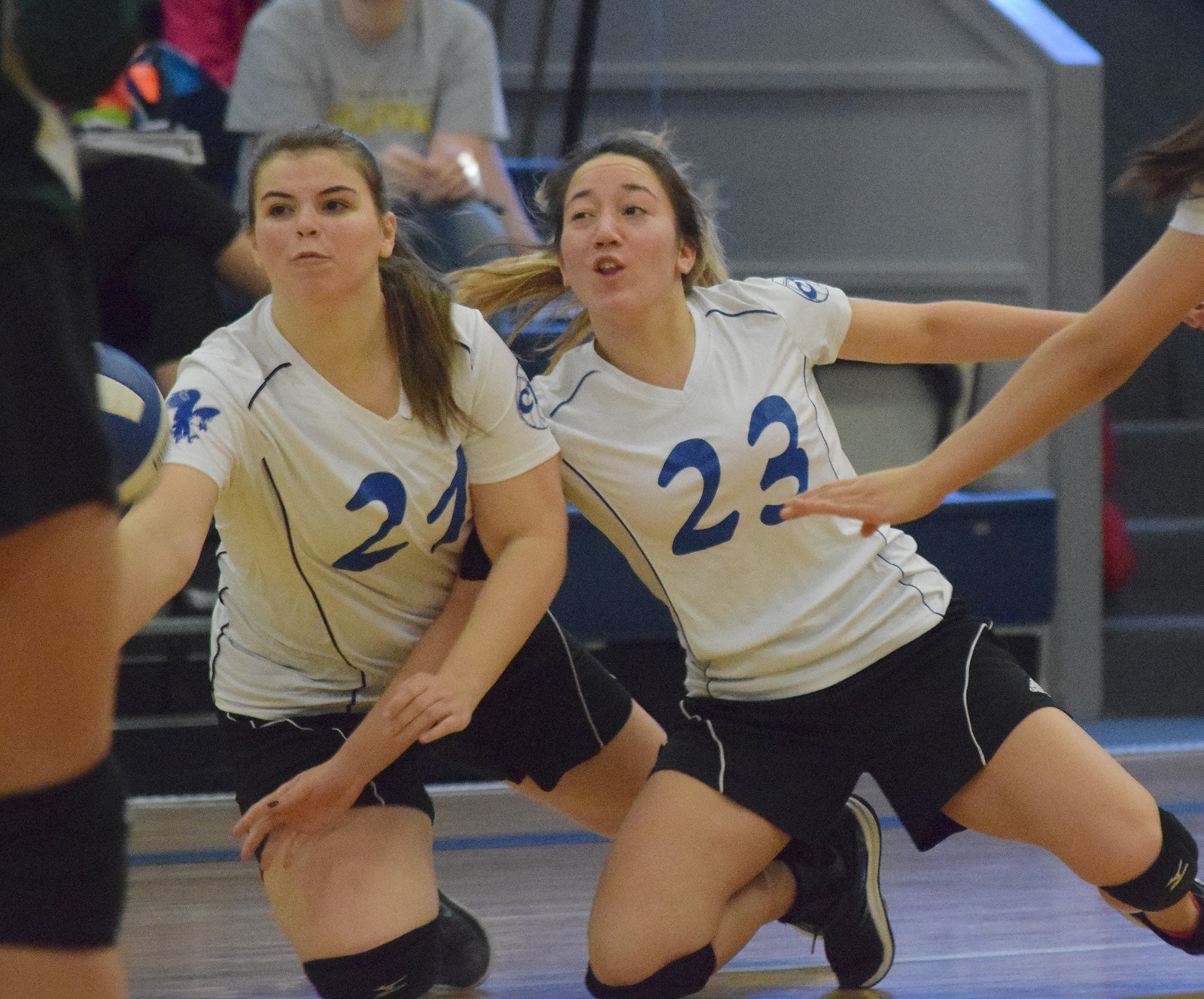 Anna Cizek (left) and Cook Inlet Academy teammate Breona Delon both dive for a ball Friday at the Borealis Conference volleyball tournament held at CIA.