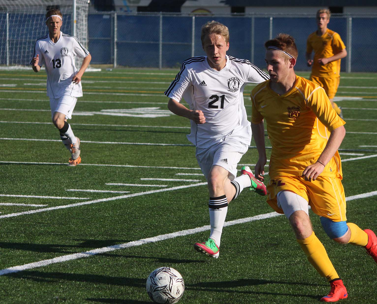 Kenai freshman Riley McKee hounds Dimond defender Kyle Stone during Friday's state soccer semifinal at Bartlett High in Anchorage. Dimond won 3-0.