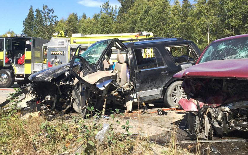 Two vehicles involved in a head-on collision sit on the Kenai Spur Highway north of the South Miller Loop Road intersection on Saturday, August 29 in Nikiski.