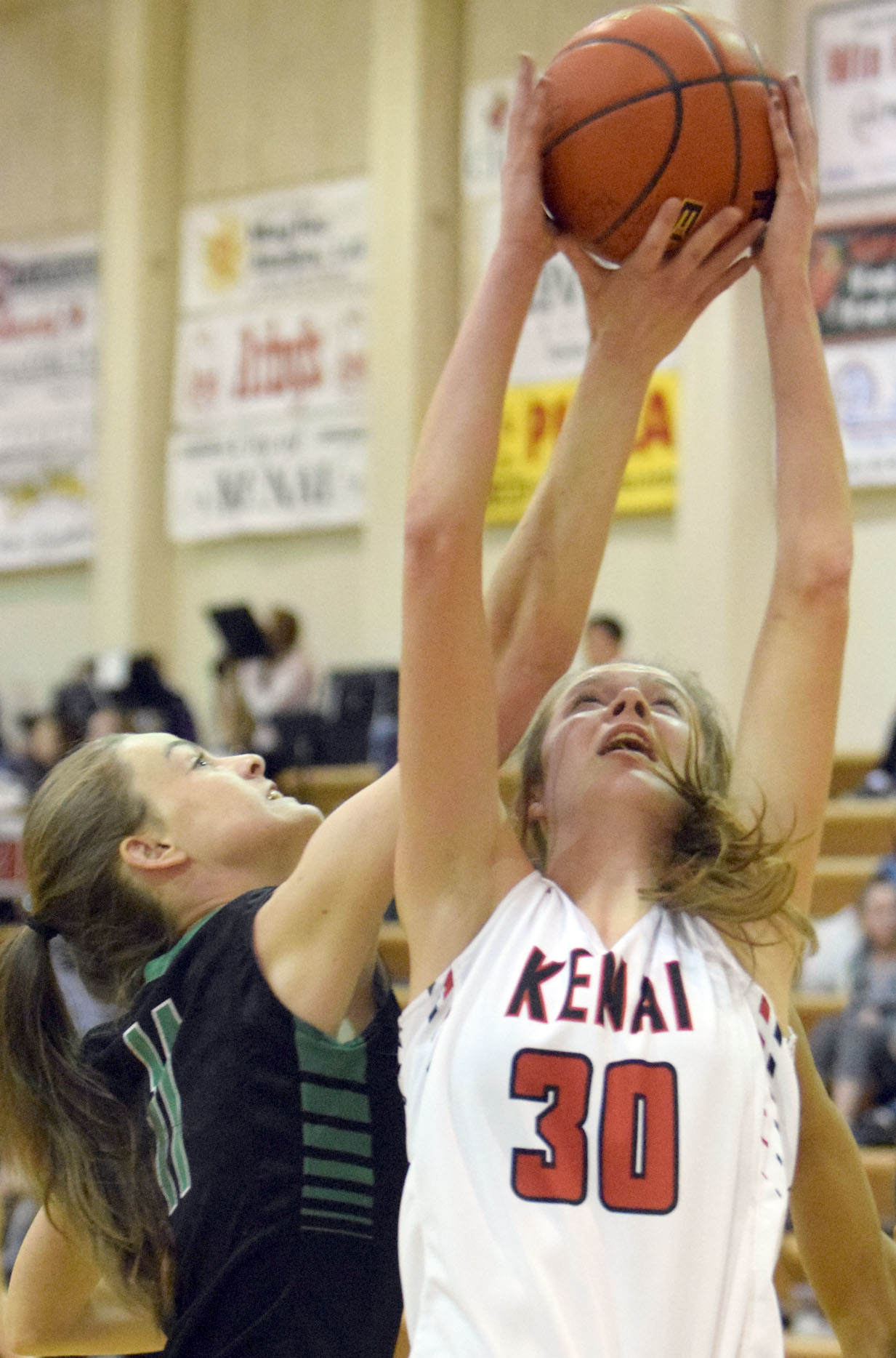 Colony's Ella Smith keeps her eye on the ball as a host of hands battle for possession Thursday, Jan. 26, 2017, at Kenai Central High School. (Photo by Jeff Helminiak/Peninsula Clarion)