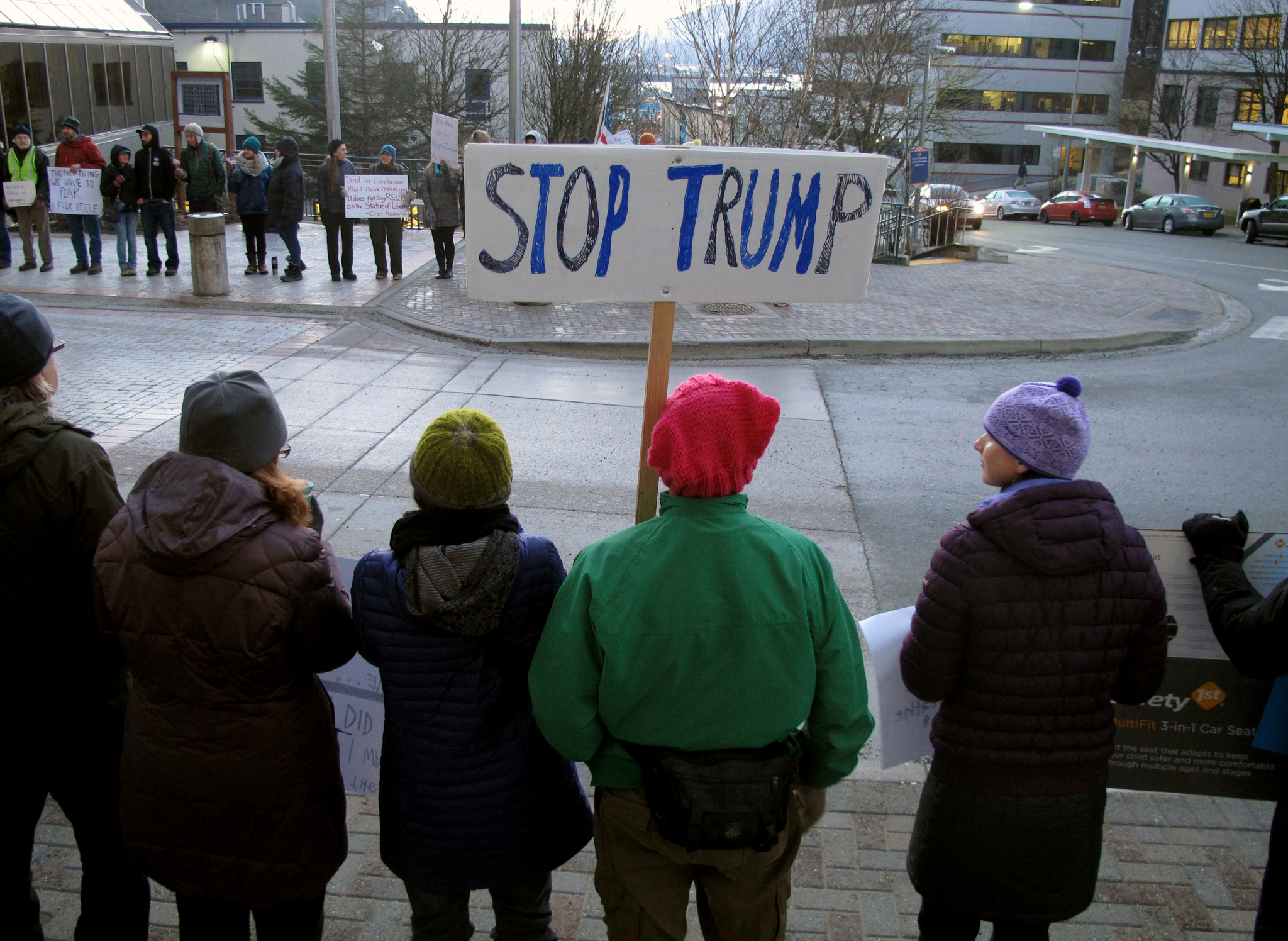 People gather in front of the Alaska Capitol on Monday, Jan. 30, 2017, in Juneau, Alaska, to protest President Donald Trump’s executive order affecting immigration and refugees. (AP Photo/Becky Bohrer)
