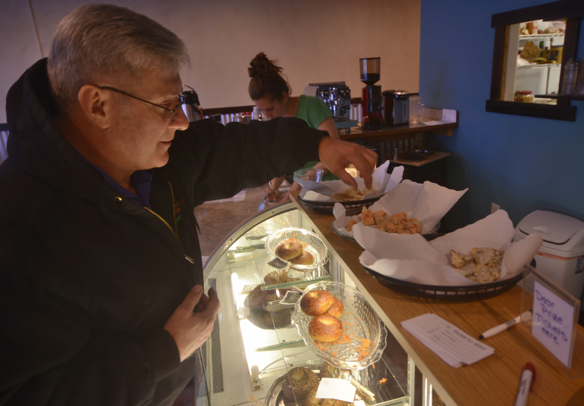 Jeff Warton samples three flavors of bagel spread at the grand opening of the Kenai location of Everything Bagels on Tuesday, Jan. 31,2017 in Kenai, Alaska. The grand opening comes 13 days after the Kenai shop had its soft opening on Jan. 18, seven months after Everything Bagels opened its first location in Soldotna on July 15, 2016, and on the one-year anniversary of co-owners Matt and Pamela Parker (with Brooke and John Campbell) making their first batch of bagels in their home kitchen, Pamela Parker said. "We came from Florida, where all the New Yorkers go to retire, so there's tons of delicious bagels there," she said. "We wanted to bring that up here." (Ben Boettger/Peninsula Clarion)