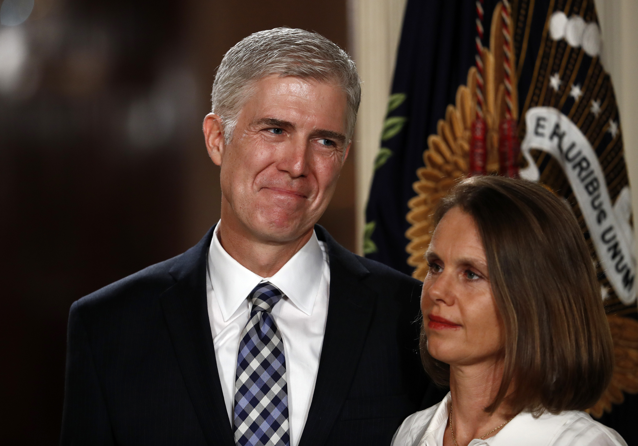 Judge Neil Gorsuch stands with his wife Louise as President Donald Trump speaks in the East Room of the White House in Washington, Tuesday, Jan. 31, 2017, to announce Gorsuch as his nominee for the Supreme Court.(AP Photo/Carolyn Kaster)