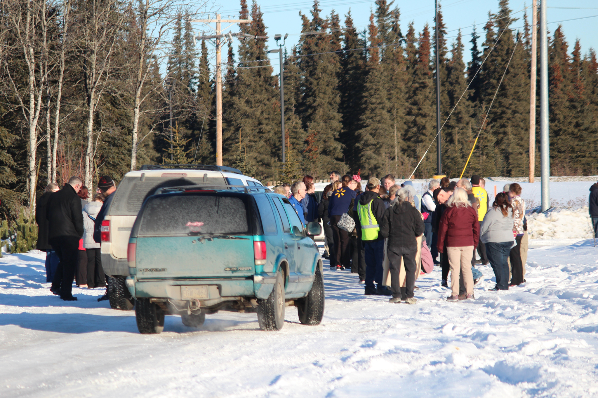 Customers and employees stand in the parking lot of the former Lowe’s building after being evacuated from the Kenai Walmart on Thursday, Feb. 2, 2017 in Kenai, Alaska. Local law enforcement officers responded to a bomb threat called in to the store around 12:30 p.m. and evacuated the building during their search. They found no explosive devices. (Megan Pacer/Peninsula Clarion)