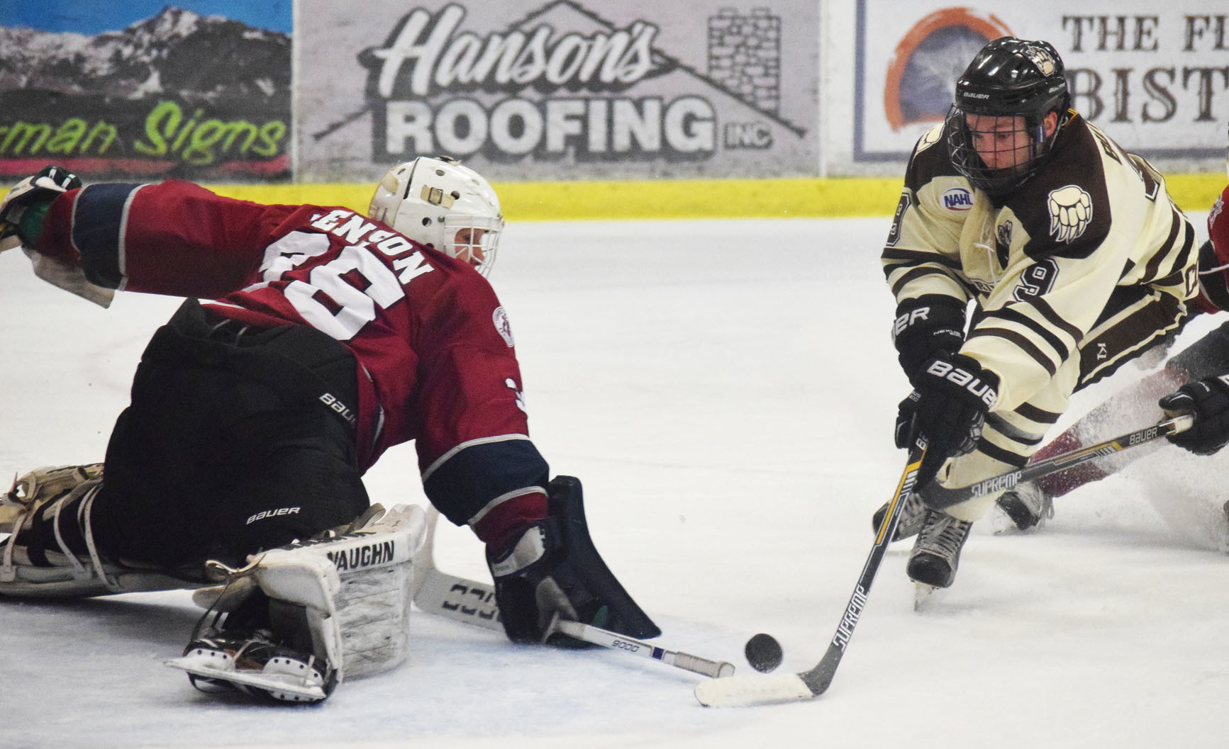 Fairbanks goaltender Josh Benson wards off a shot by Kenai River forward Evan Butcher (9) Friday night at the Soldotna Regional Sports Complex. (Photo by Joey Klecka/Peninsula Clarion)