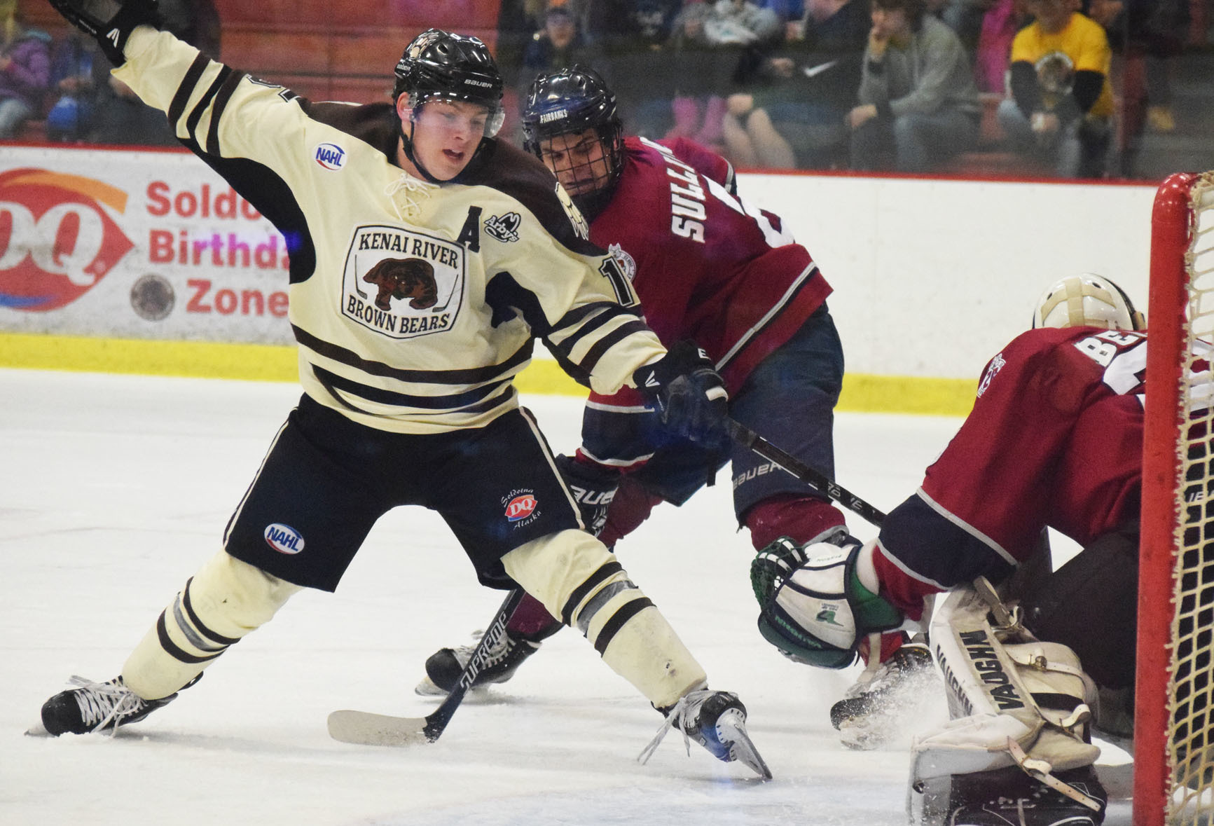 Brown Bears skater Luke Radetic works the puck across the Fairbanks crease in front of Ice Dogs goalie Josh Benson Friday night at the Soldotna Regional Sports Complex. (Photo by Joey Klecka/Peninsula Clarion)
