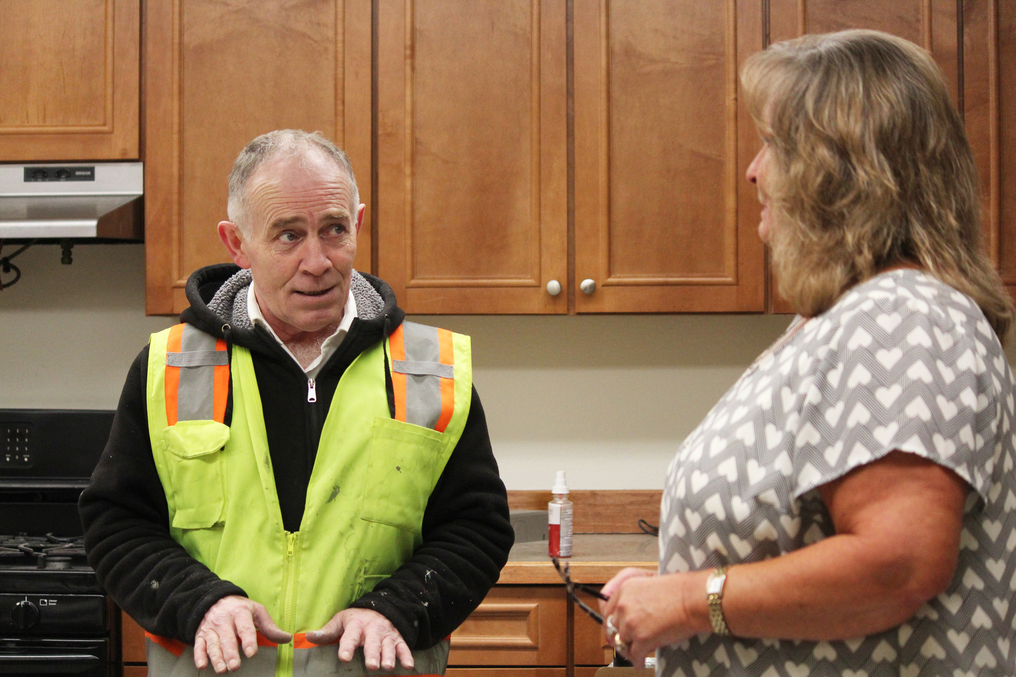 Jay Johnson, superintendent at Blazy Construction, talks with LeeShore Center Executive Director Cheri Smith about the renovation to the center’s kitchen Wednesday, Feb. 1, 2017 at the center in Kenai, Alaska. (Megan Pacer/Peninsula Clarion)