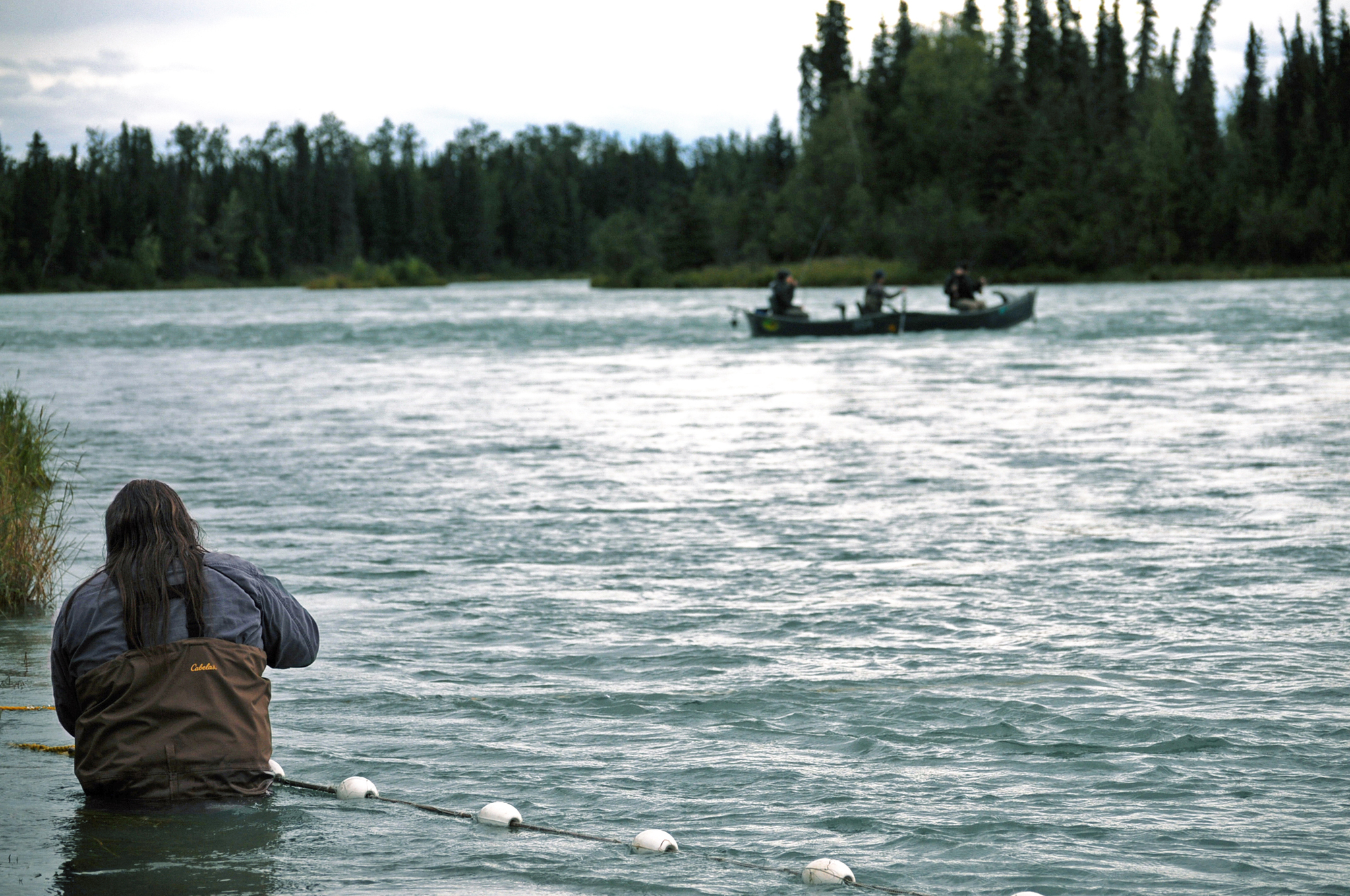 Ninilchik Traditional Council Resource and Environmental Director Darrel Williams checks the tribe’s subsistence gillnet for fish on the Kenai River on Sunday, Aug. 14, 2016 near Soldotna, Alaska. The tribe gained approval for the controversial net on July 27 and was able to fish it until Aug. 15. (Photo by Elizabeth Earl/Peninsula Clarion, file)