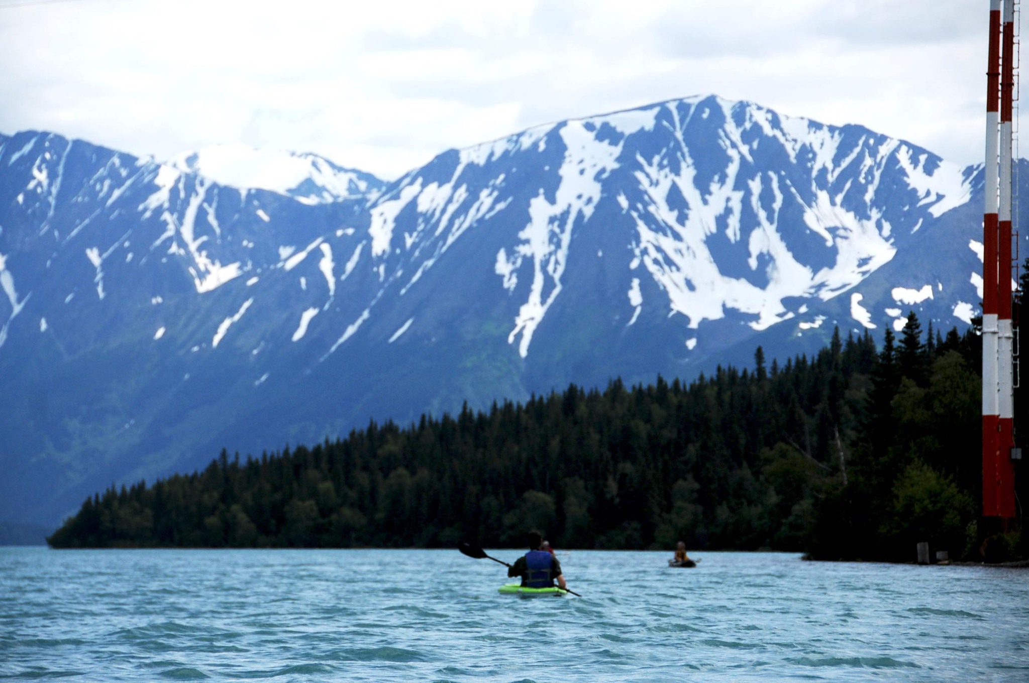 In this July 2016 photo, kayakers make their way across Kenai Lake in Cooper Landing, Alaska. (Elizabeth Earl/Peninsula Clarion)