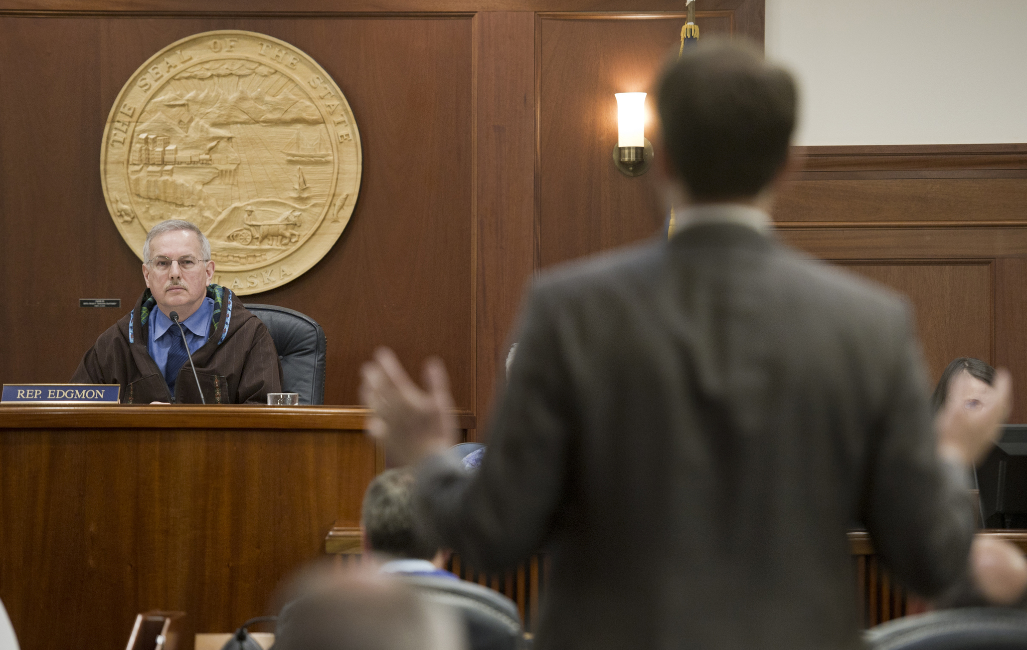 Speaker of the House Bryce Edgmon, D-Dillingham, listens to Rep. Lance Pruitt, R-Anchorage, make a statement about the new majority’s procedures during a House session on Friday. (Michael Penn | Juneau Empire)