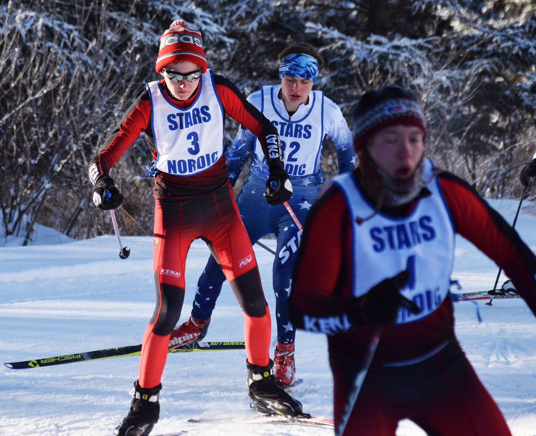 Kenai Central’s Eric Kempf (3) battles Kards teammate Patrick Michels and Soldotna’s Addison Downing early in Saturday’s Kenai Peninsula Borough boys race on the Tsalteshi Trails. (Photo by Joey Klecka/Peninsula Clarion)