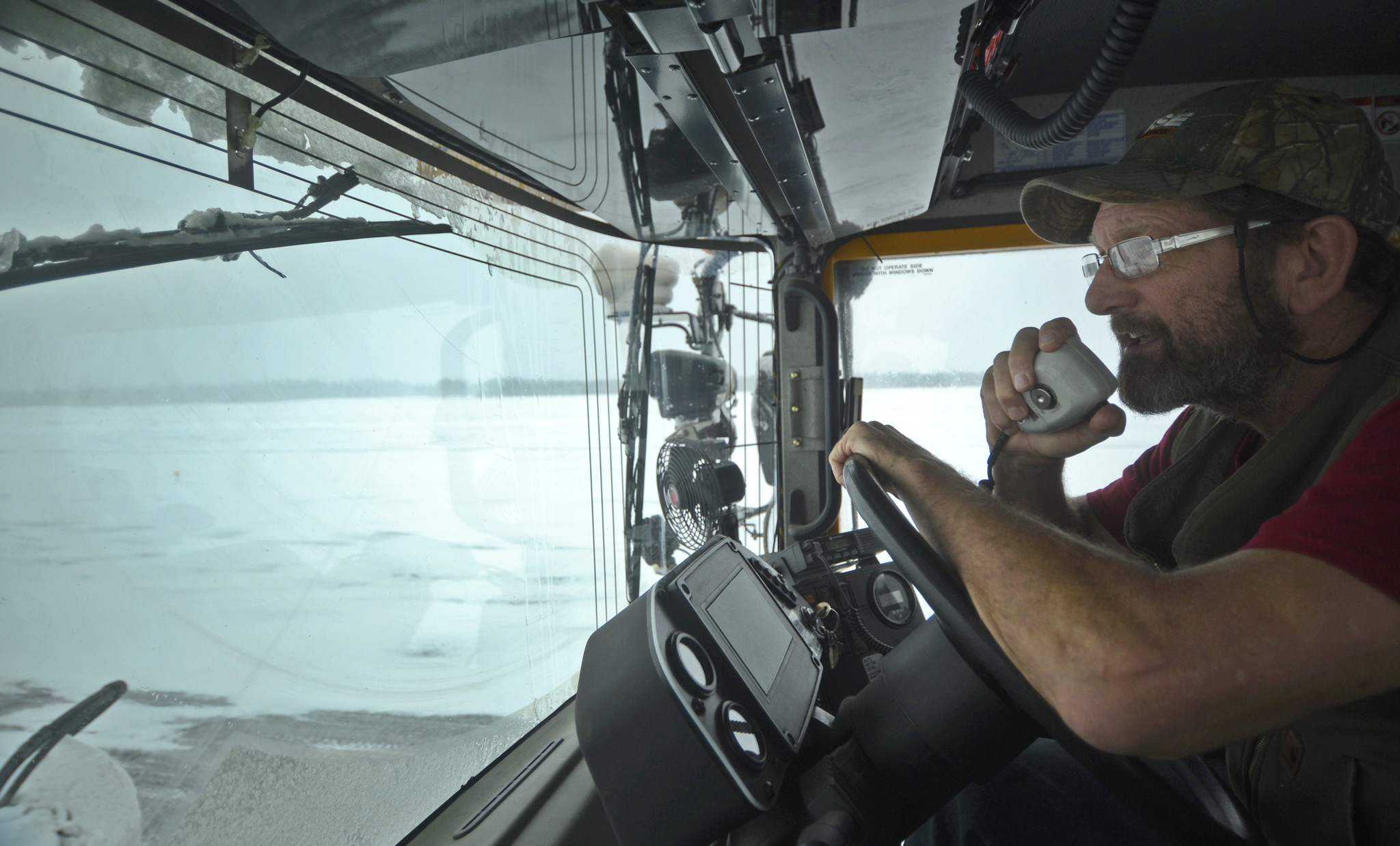 Equipment operator Terry Russ drives a broom machine up and down the runway of the Kenai Municipal Airport on Monday, Feb. 13, 2017 in Kenai, Alaska. Russ had been at work since 4 a.m doing what he called “probably the most monotonous job on the airport” to keep the runway clear of snow that could soldify into ice. On heavy snow days, two broom machines drive down each side of the runway centerline, whirling away snow with heavy rotary brushes while a plow truck scrapes off packed snow and ice. (Ben Boettger/Peninsula Clarion)