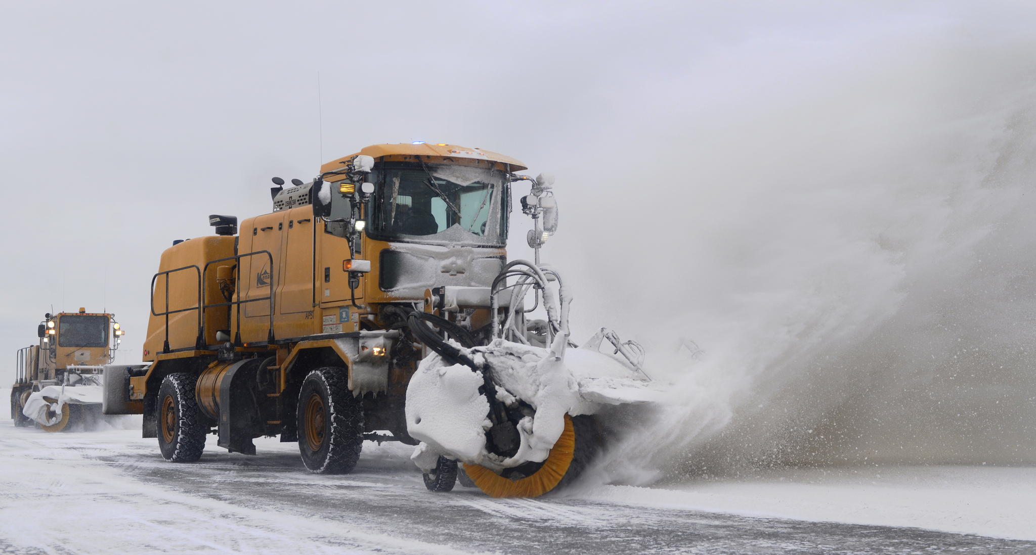 Two broom machines clear snow from in front of the Kenai Municipal Airport terminal on Monday, Feb. 13, 2017 in Kenai, Alaska. (Ben Boettger/Peninsula Clarion)