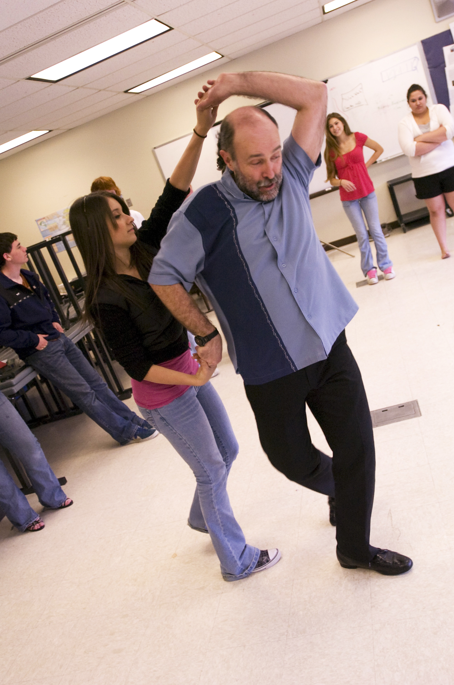 Eddie Wood, of Homer, demonstrates dance steps with Stephanie Almaraz in a Spanish class on May 5, 2008 at Soldotna High School. Wood, who travels the peninsula playing percussion and teaching salsa, is hosting his first open class for adults in Soldotna with local artist Kaitlin Vadla on Thursday. (Scott Moon/Peninsula Clarion-File)