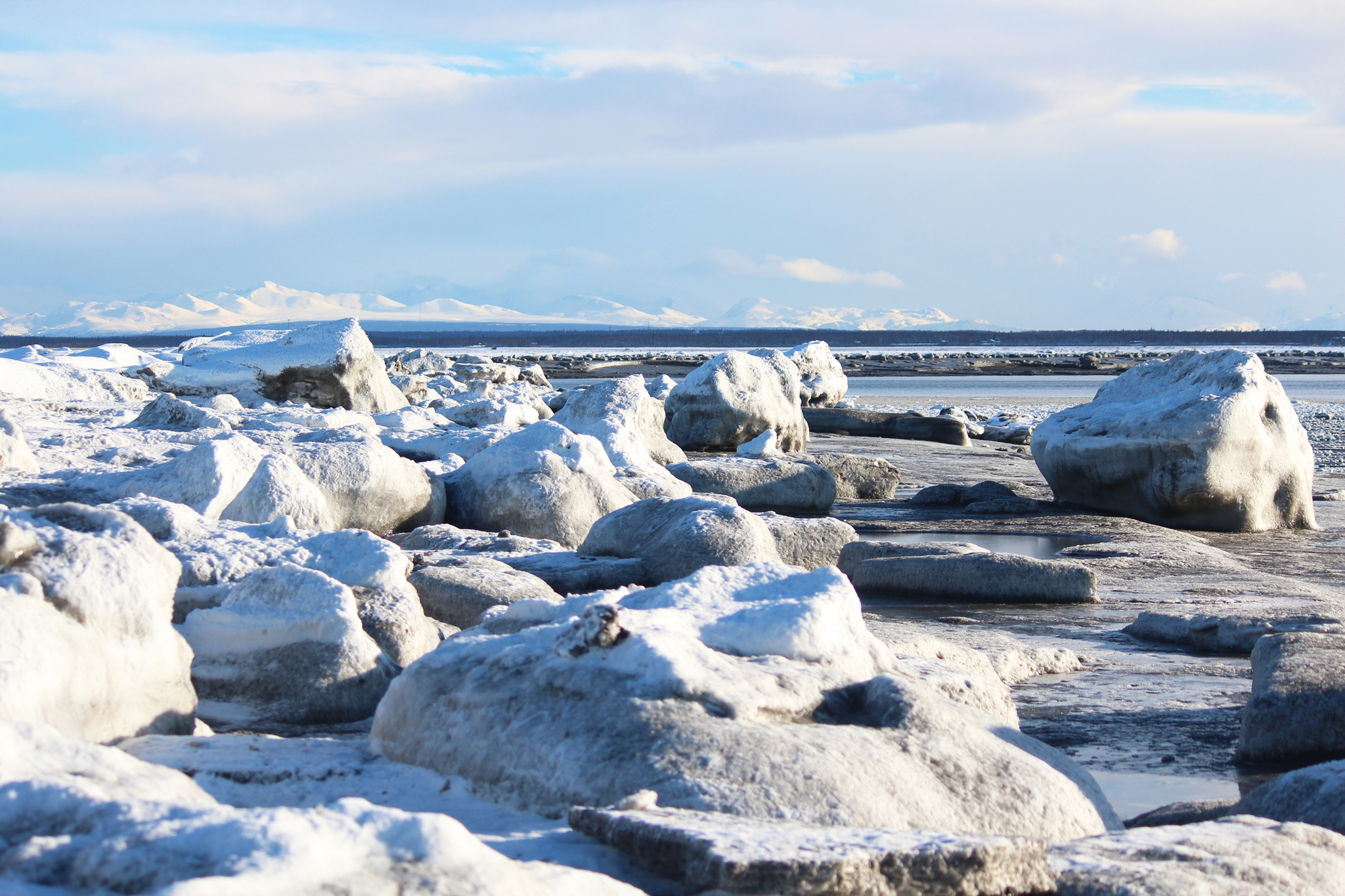 Chunks of frozen ice and sand line the beach at the mouth of the Kenai River on Wednesday, Feb. 15, 2017 in Kenai, Alaska. Kenai has been in a warm spell this week, with a high near 36 degrees on Wednesday afternoon. Warm weather is expected to continue, with highs in the 30s through Friday, according to the National Weather Service. (Megan Pacer/Peninsula Clarion)