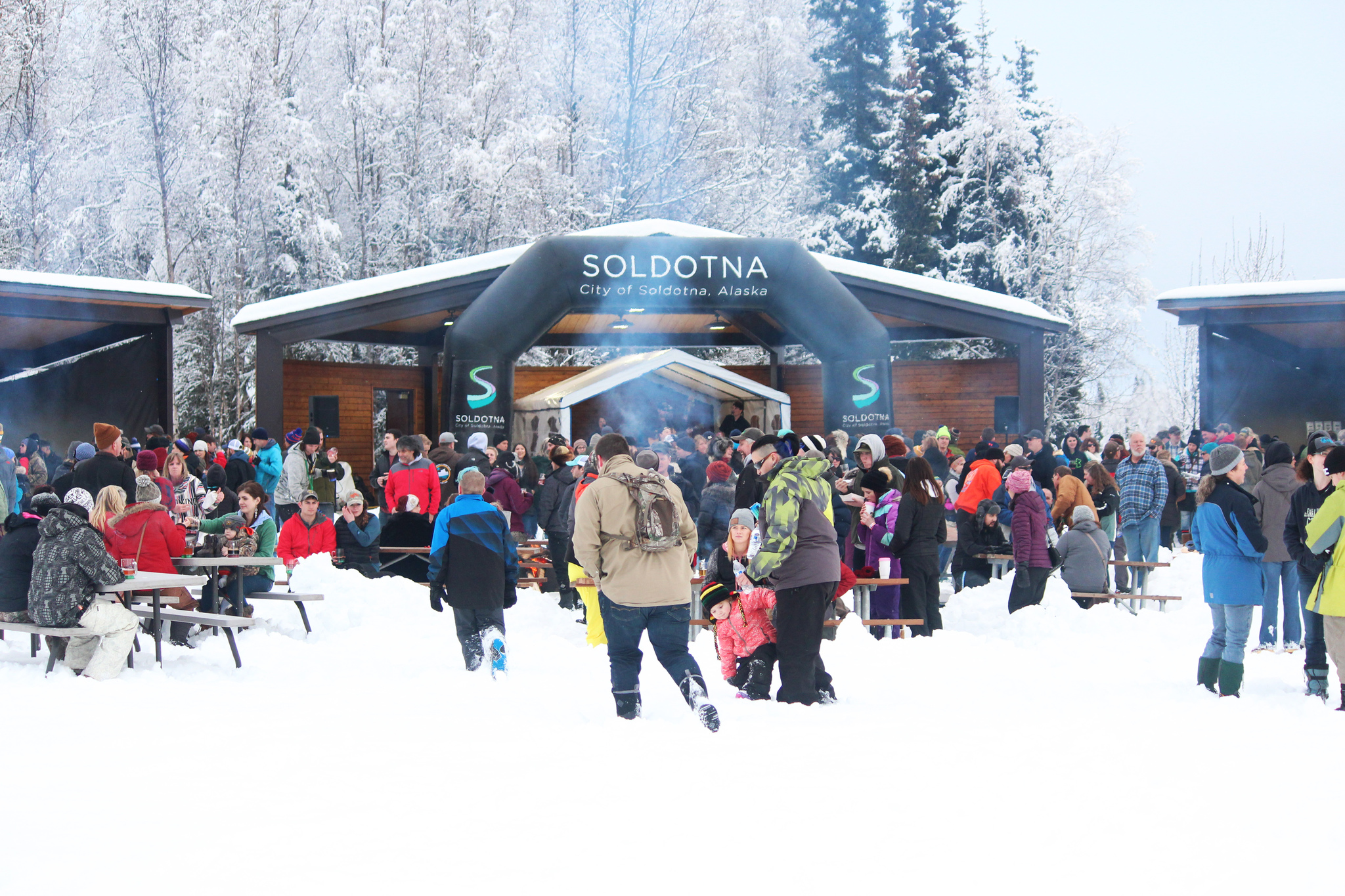 Area residents enjoy music and beer during the Frozen River Festival on Saturday, Feb. 18, 2017 at Soldotna Creek Park in Soldotna, Alaska. A thick layer of snow on the ground didn’t stop the sizeable crowd from flocking to the park for the third annual event. This year’s festival was extended to include evening fireworks. (Megan Pacer/Peninsula Clarion)