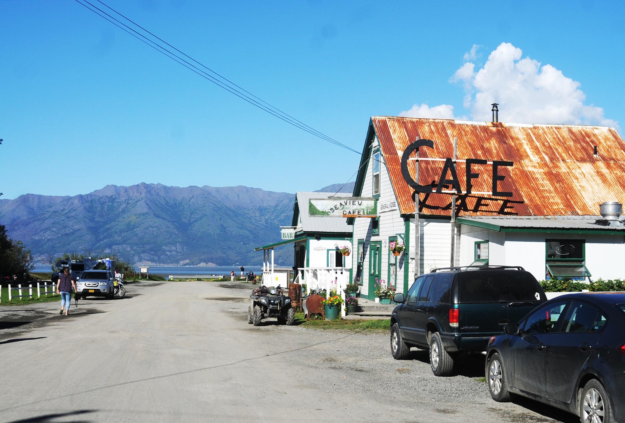 In this August 2016 picture, people walk along the main historic downtown street of Hope, Alaska. Hope, a small unincorporated town along the Turnagain Arm at the end of the 18-mile Hope Highway, is a popular tourist destination in the summer months for its hiking and boating opportunities and for its historical value. (Elizabeth Earl/Peninsula Clarion)