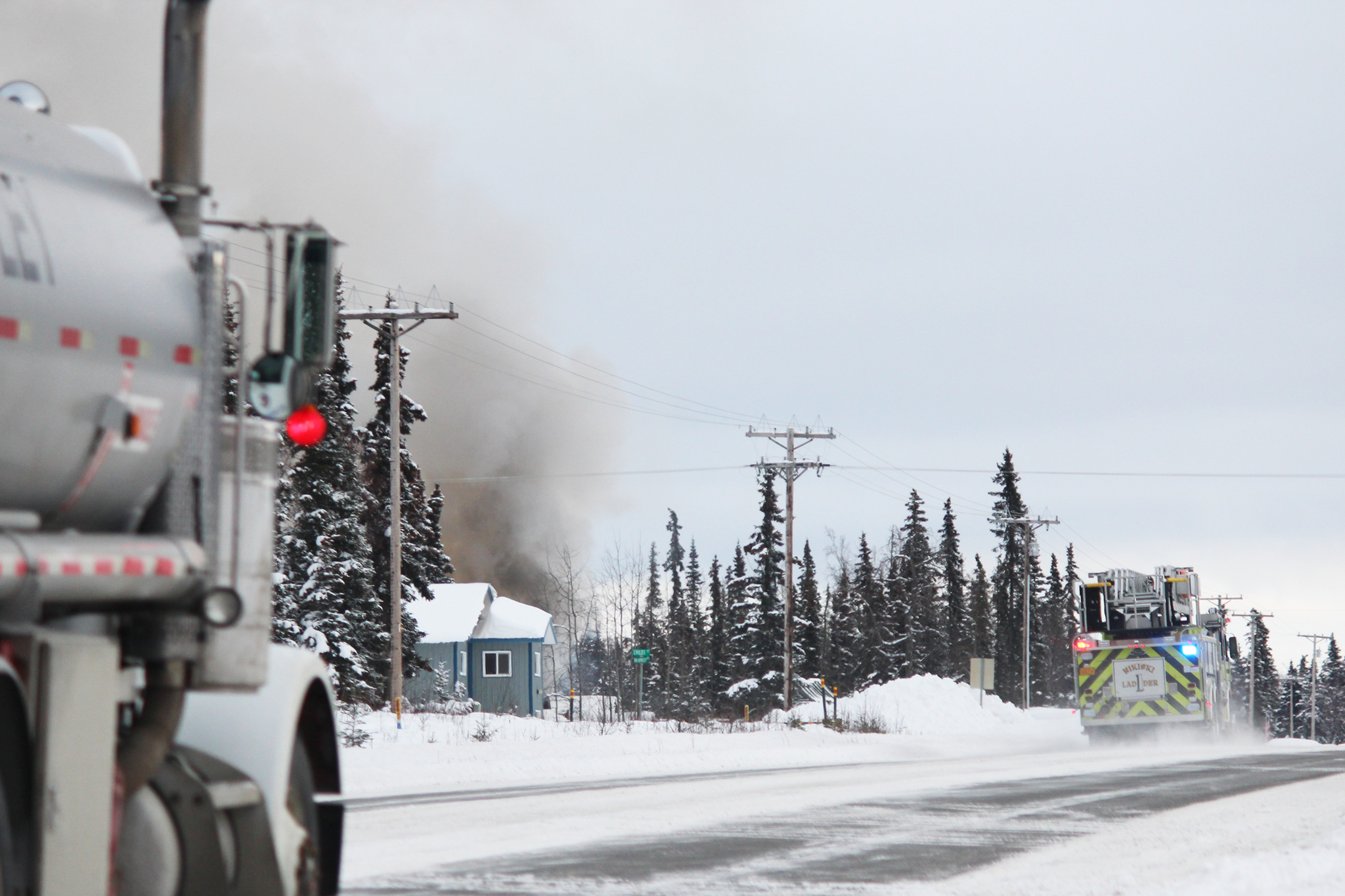 A Nikiski Fire Department engine arrives on the scene of a structure fire on Bridge Access Road on Wednesday, Feb. 22, 2017 in Kenai, Alaska. (Megan Pacer/Peninsula Clarion)