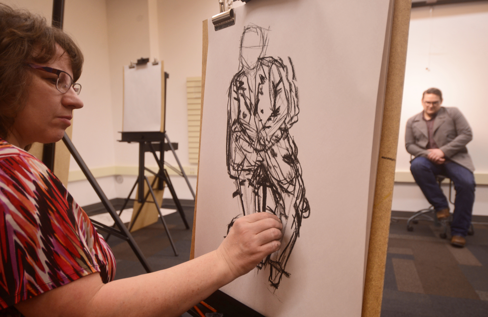 Marlene Lewis (left) sketches model Robert Dederick during a charcoal figuring-drawing class on Thursday, Feb. 23, 2017 at the Kenai Community Library in Kenai, Alaska. The class is the latest in a series of community art classes lead by artist and Kenai librarian James Adcox.