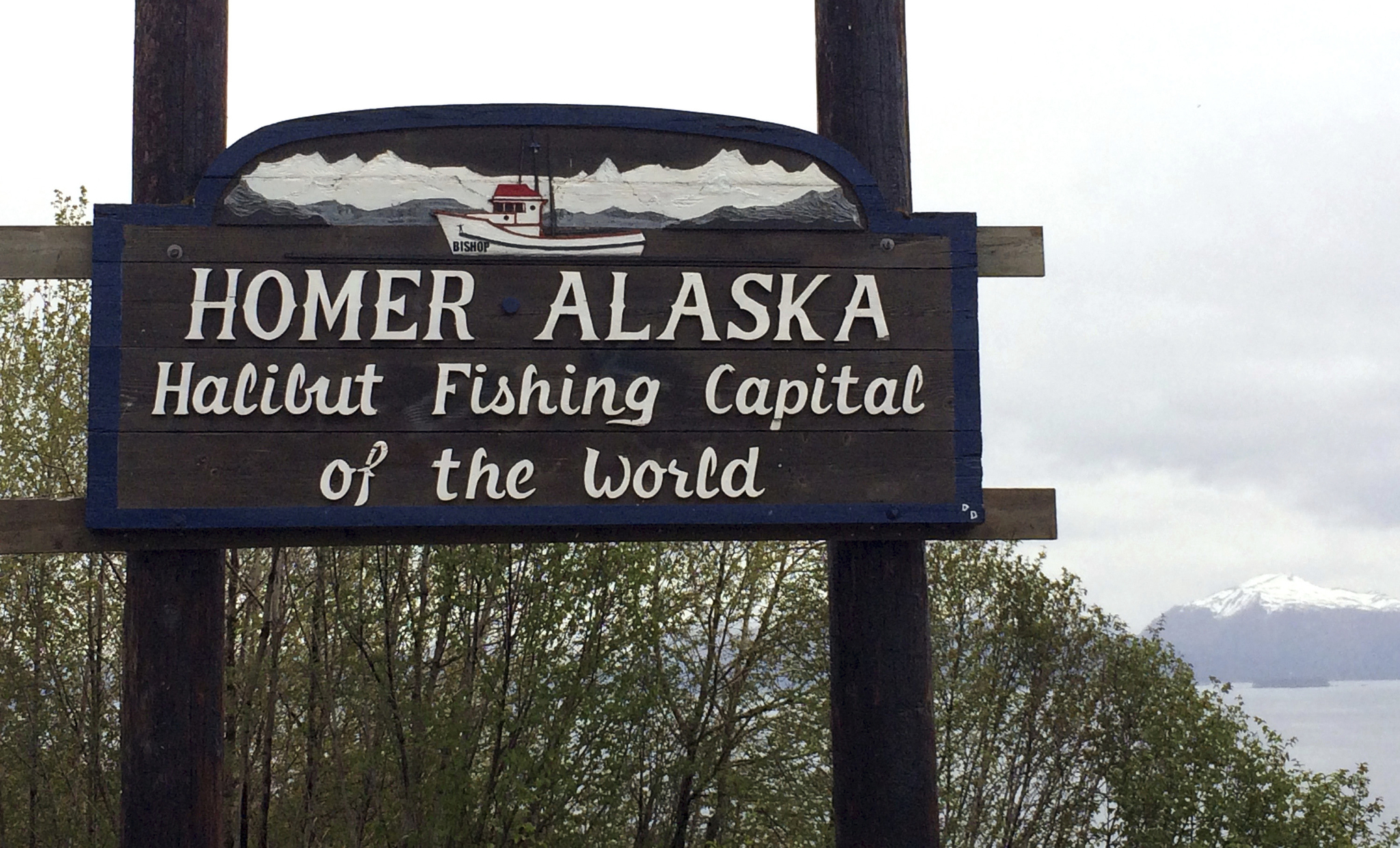 In this May 23, 2015, photo the welcome sign is displayed on the outskirts of Homer, Alaska. The fishing town is the latest U.S. city to consider affirming its commitment to inclusion amid national concerns about the treatment of immigrants, religious minorities and others. Homer city leaders are expected to weigh a resolution Monday that says Homer will resist any efforts to profile “vulnerable populations.” (AP Photo/Mark Thiessen)
