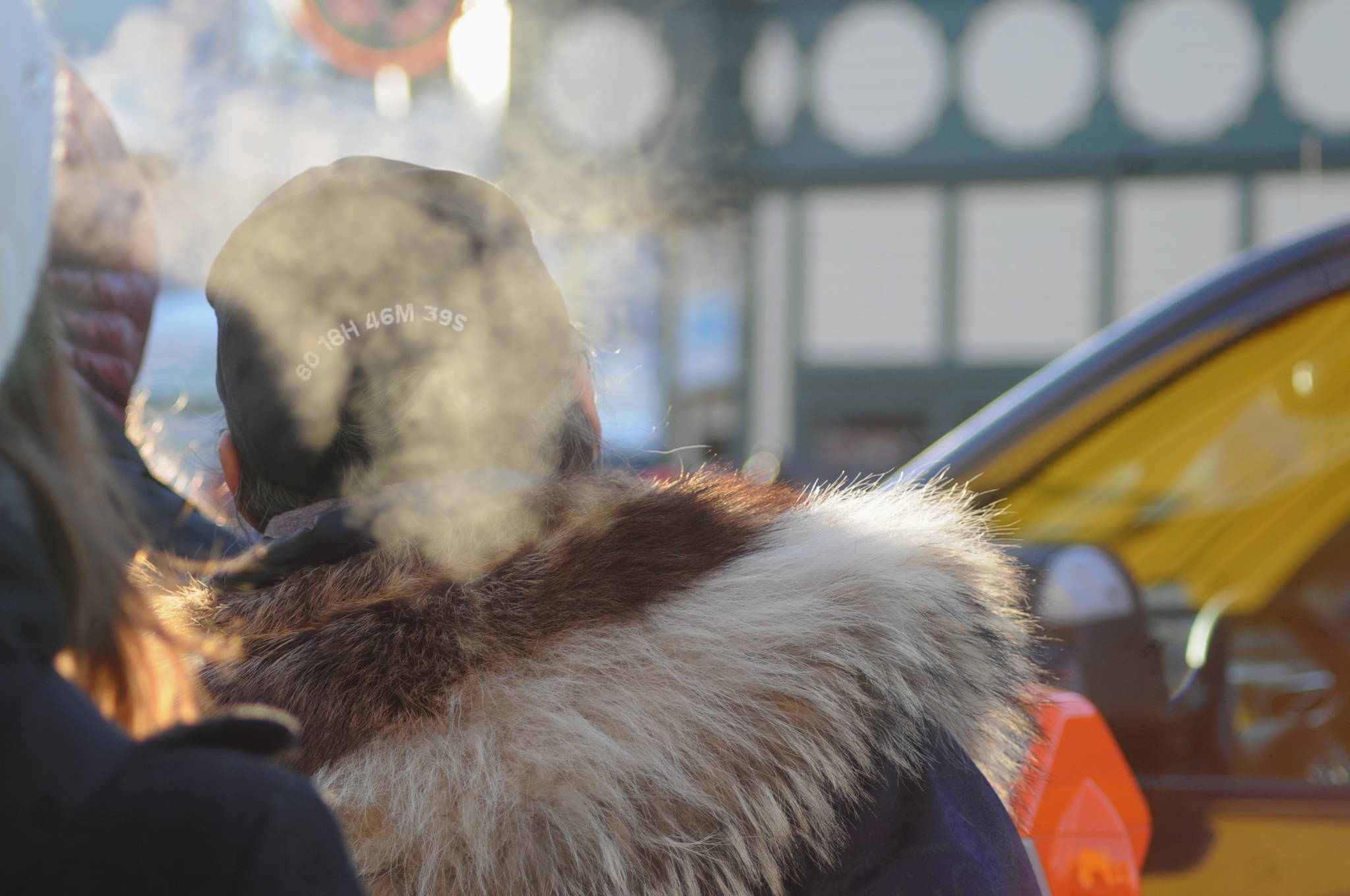 A spectator cranes over the crowd near the starting line at the ceremonial start of the 45th Iditarod sled dog race Saturday, March 4, 2017 in Anchorage, Alaska. The Iditarod is the culmination of a week-long festival called the Fur Rondy, a celebration of the end of the trapping season when, historically, trappers would come to Anchorage to auction off their furs. Many people in the crowd wore different types of fur, from lined kuspuks to fox-fur hats. (Elizabeth Earl/Peninsula Clarion)