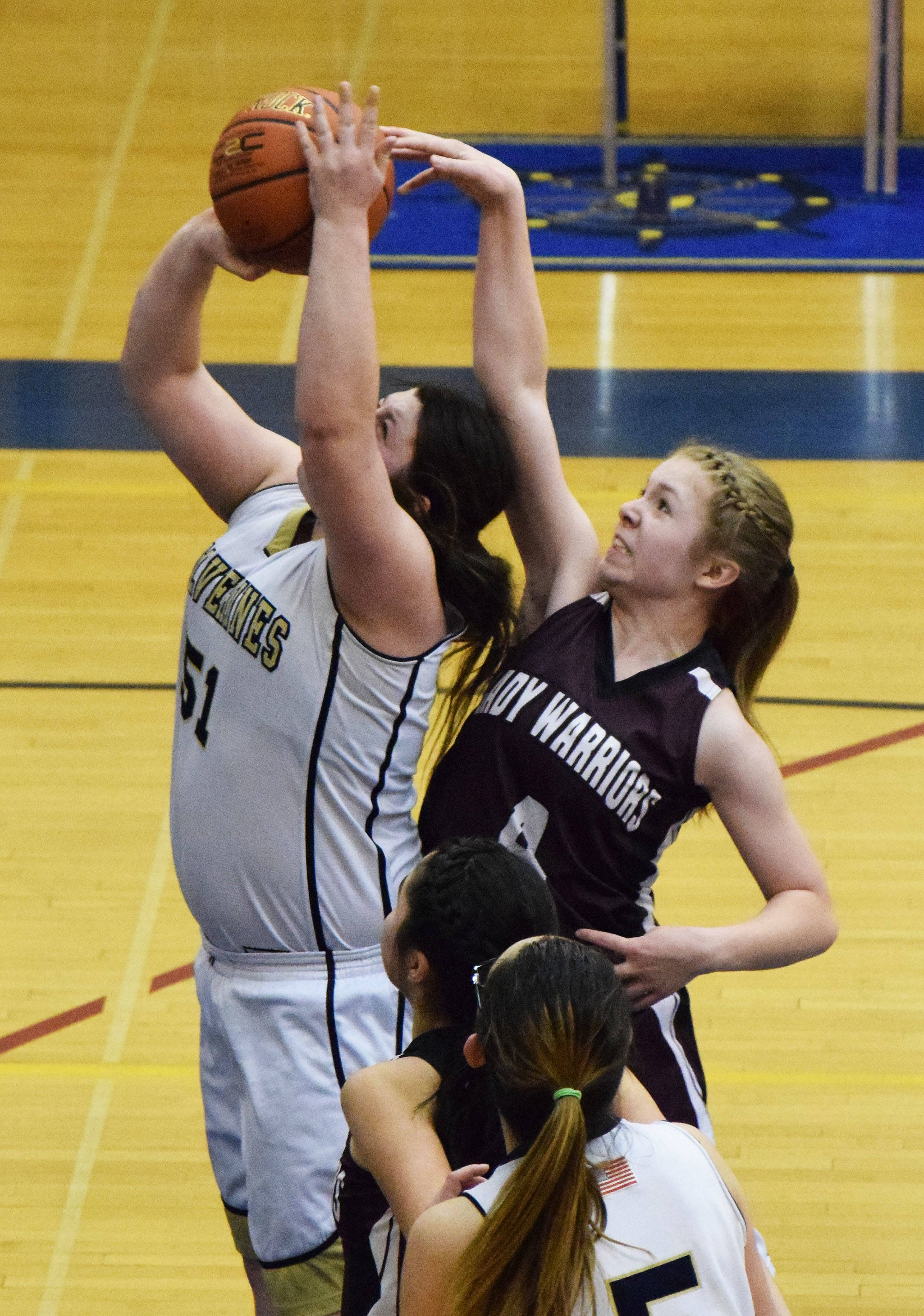 Nikolaevsk’s Kristin Klaich (right) puts a block on Ninilchik’s Mikayla Clark in Friday’s Peninsula Conference girls championship game at Homer High School. (Photo by Joey Klecka/Peninsula Clarion)