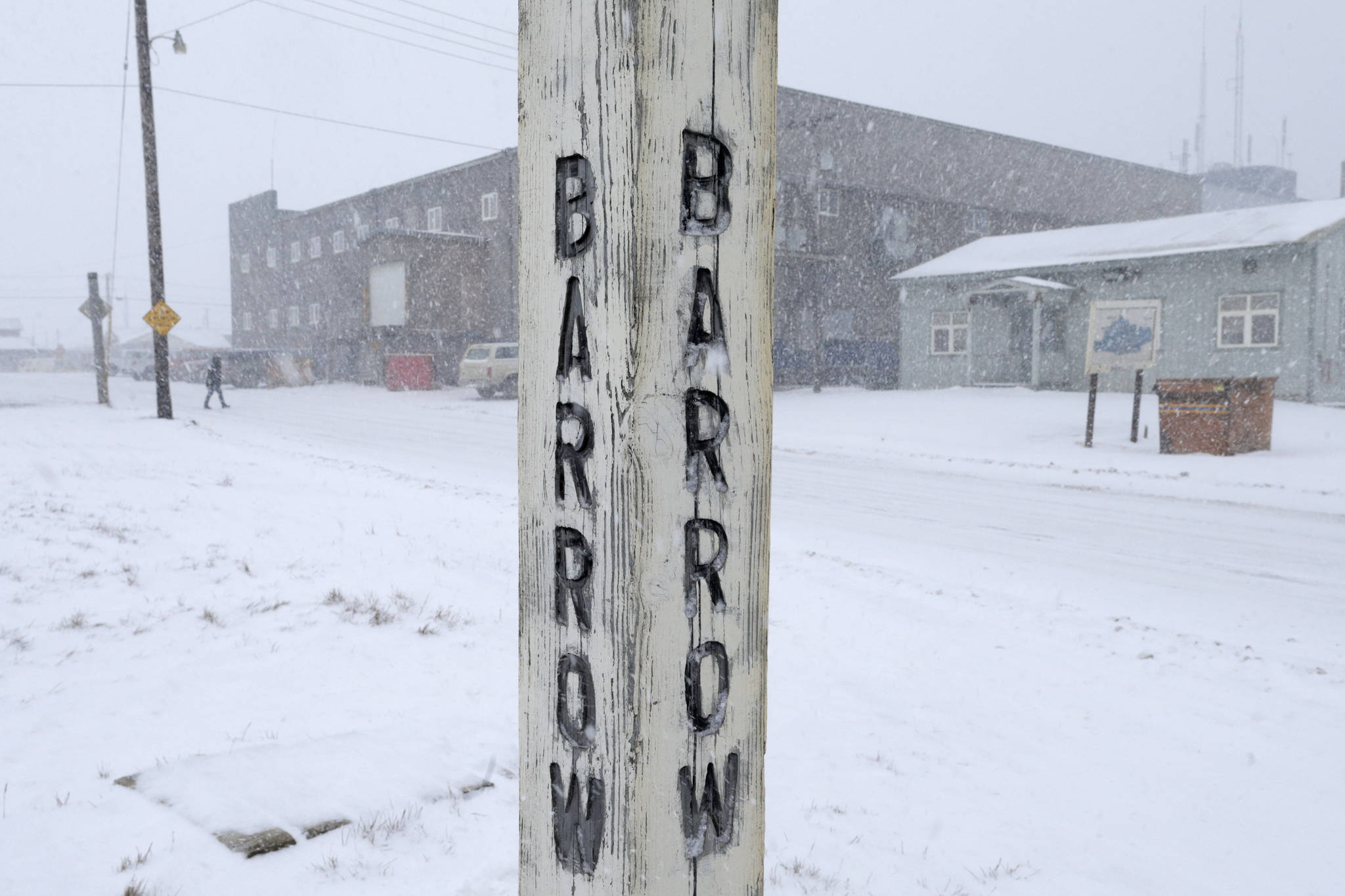 In this Oct. 10, 2014, file photo, snow falls around a sign in Barrow, Alaska. A court hearing is set for Thursday, March 9, 2017, in Alaska for the two sides in a lawsuit challenging the new Inupiat Eskimo name of the nation’s northernmost town. Voters in the town formerly known as Barrow approved the new name, Utqiagvik, by six votes last October. (AP Photo/Gregory Bull, File)