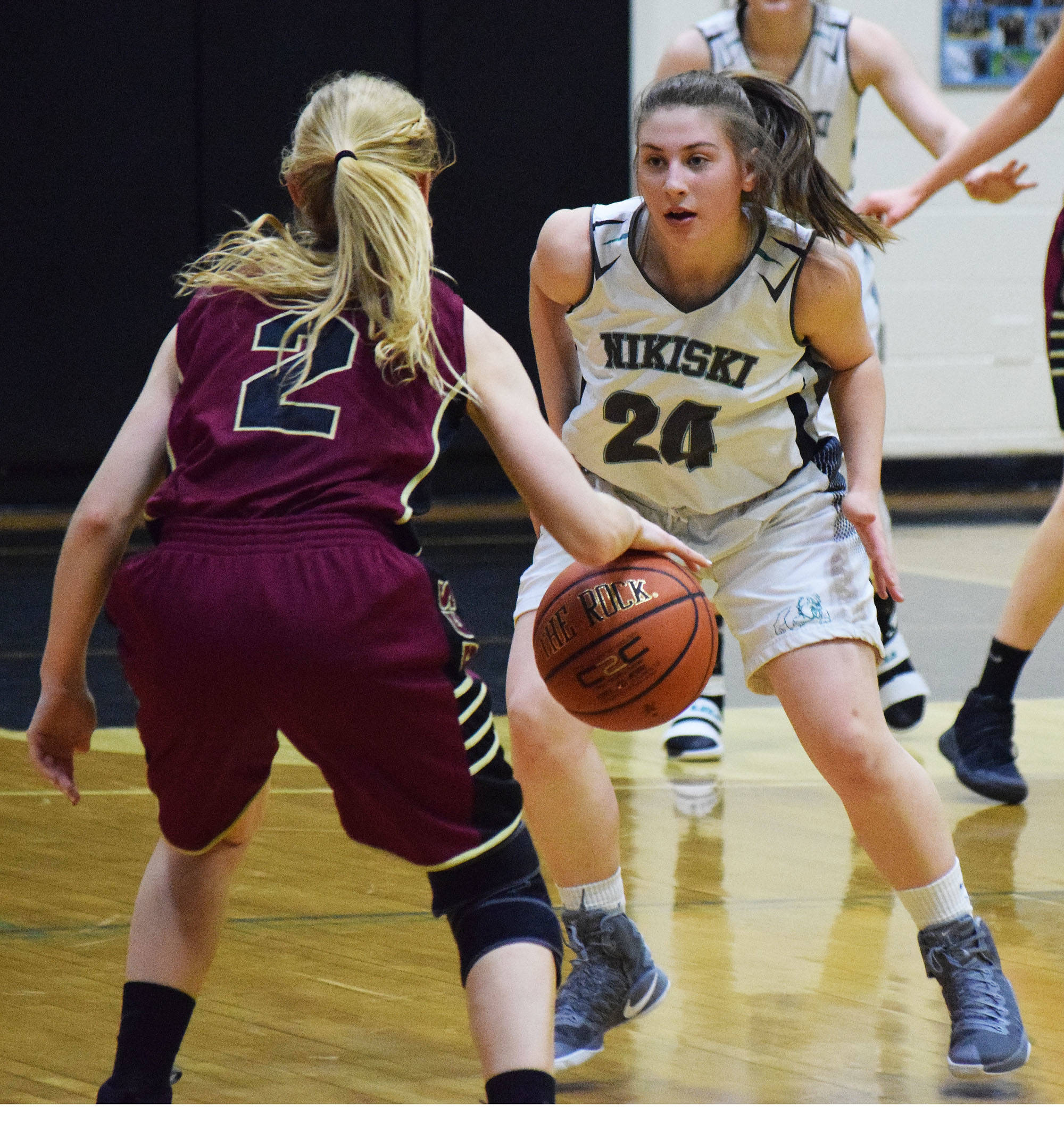 Nikiski’s Kelsey Clark (24) eyes Grace Christian’s Annie VanderWeide in Friday’s semifinal at the Southcentral Conference basketball tournament at Nikiski High School. (Photo by Joey Klecka/Peninsula Clarion)