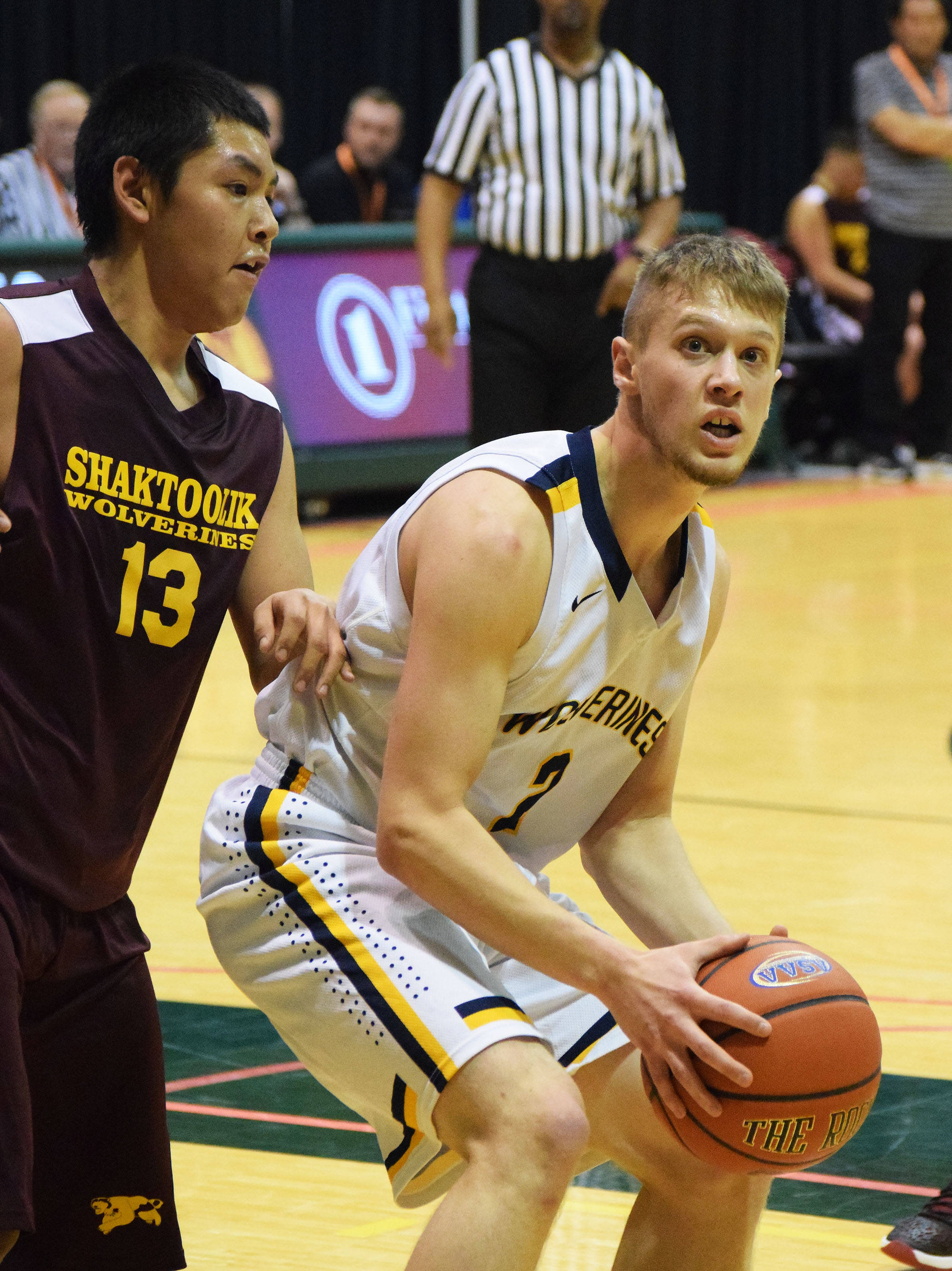 Ninilchik’s Tyler Presley drives down the lane against Shaktoolik’s Joshua Takak (13) Thursday, March 16, 2017, afternoon at the Class 1A state basketball tournament at the Alaska Airlines Center in Anchorage. (Photo by Joey Klecka/Peninsula Clarion)