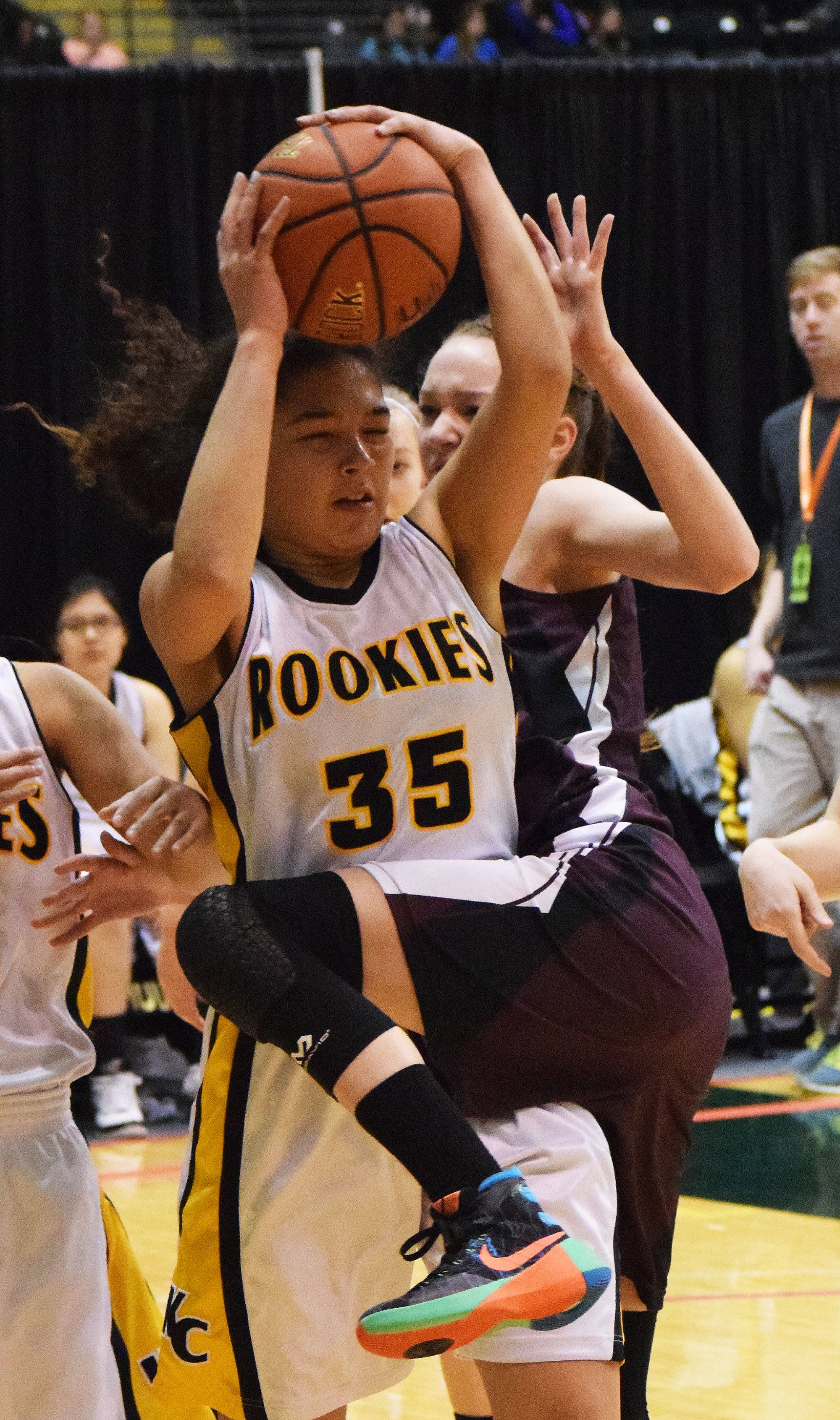 Nikolaevsk’s Elizabeth Fefelov tangles with King Cove’s Jalaya Duarte (35) Thursday, March 16, 2017, afternoon at the Class 1A state basketball tournament at the Alaska Airlines Center in Anchorage. (Photo by Joey Klecka/Peninsula Clarion)