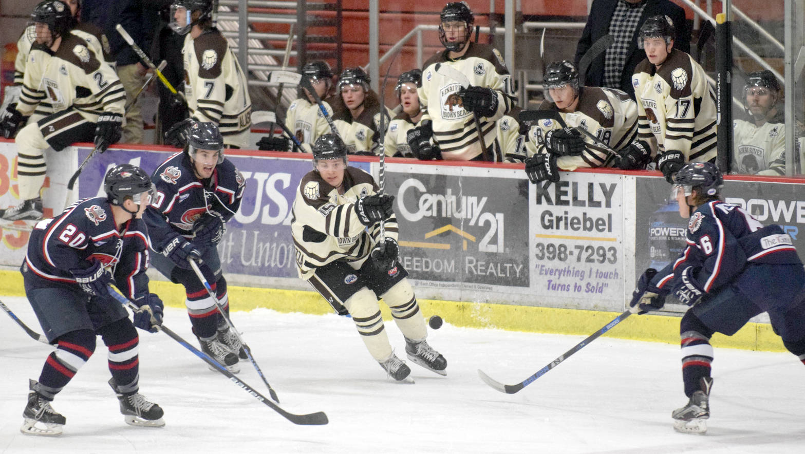 Kenai River Brown Bears forward Luke Radetic chips the puck out of danger as Topeka RoadRunners’ Will Schlagenhauf, Jeff Makowski and Jay Keranen pursue Thursday, March 16, 2017, at the Soldotna Regional Sports Complex. (Photo by Jeff Helminiak/Peninsula Clarion)