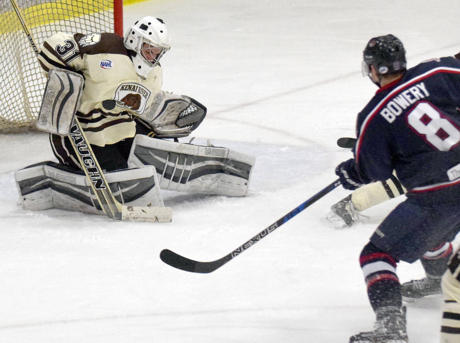 Kenai River Brown Bears goaltender Colt Hanks gets his body in front of a shot as Topeka (Kansas) RoadRunners forward Marshall Bowery lurks looking for the rebound Friday, March 17, 2017, at the Soldotna Regional Sports Complex. (Photo by Jeff Helminiak/Peninsula Clarion)