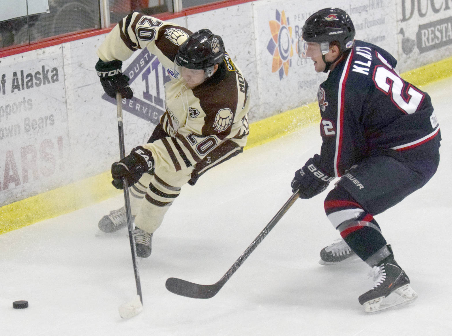 Kenai River Brown Bears defenseman Shayne Monahan and Topeka (Kansas) RoadRunners forward Kyle Klatt battle for the puck Friday, March 17, 2017, at the Soldotna Regional Sports Complex. (Photo by Jeff Helminiak/Peninsula Clarion)