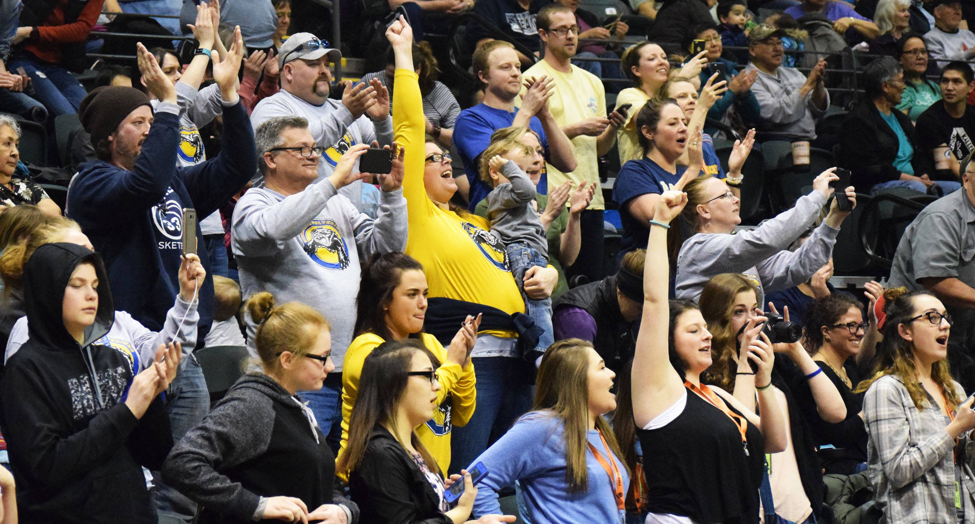 A crowd of Ninilchik supporters cheer on the Wolverines in the Class 1A boys state championship Saturday at the Alaska Airlines Center in Anchorage. (Photo by Joey Klecka/Peninsula Clarion)