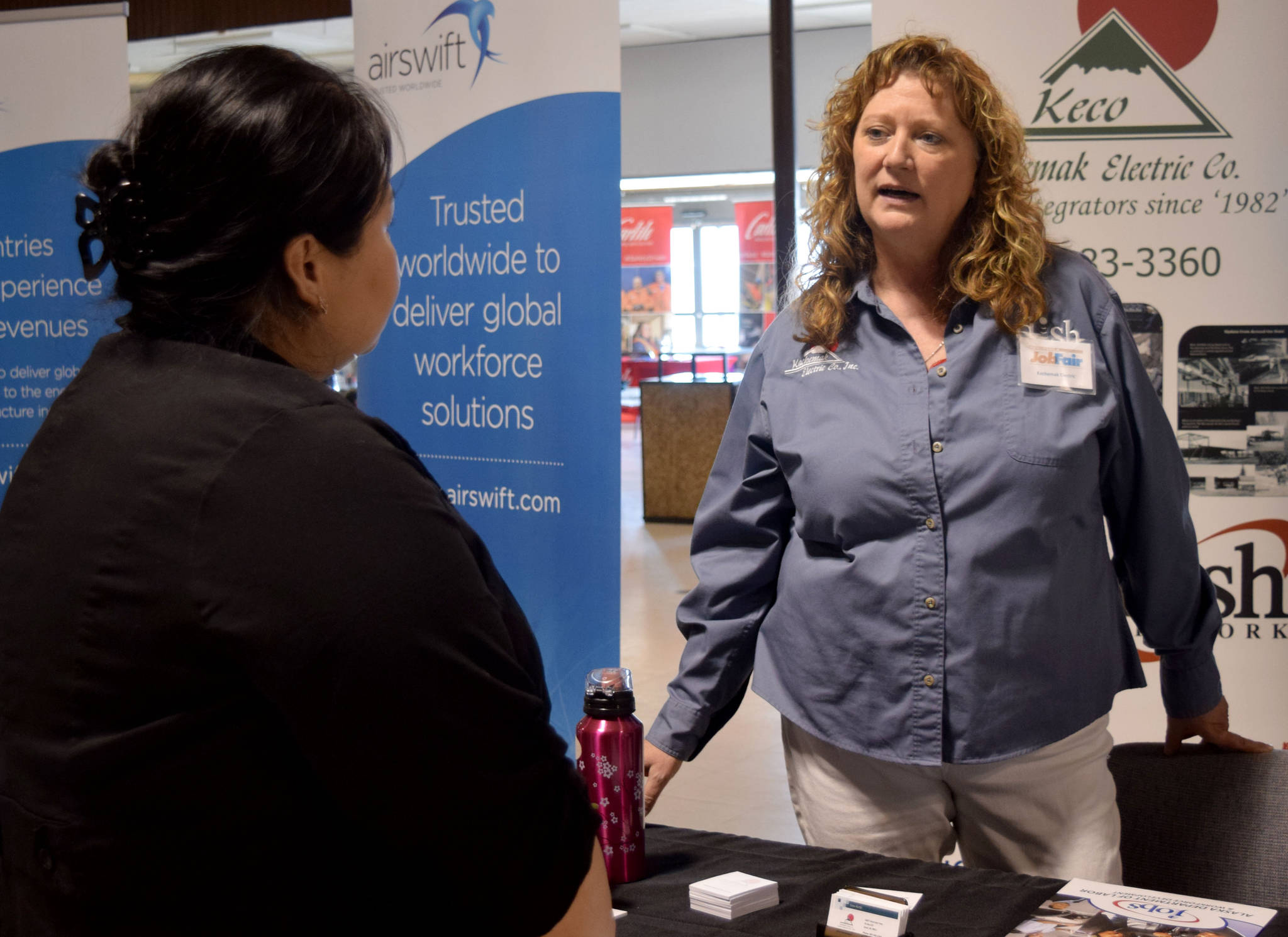 Gina Keith, office manager at Kachemak Electric, spoke with job seekers on March 22 at Kenai Peninsula Job Fair held at Peninsula Job Center. (Kat Sorensen/Peninsula Clarion)