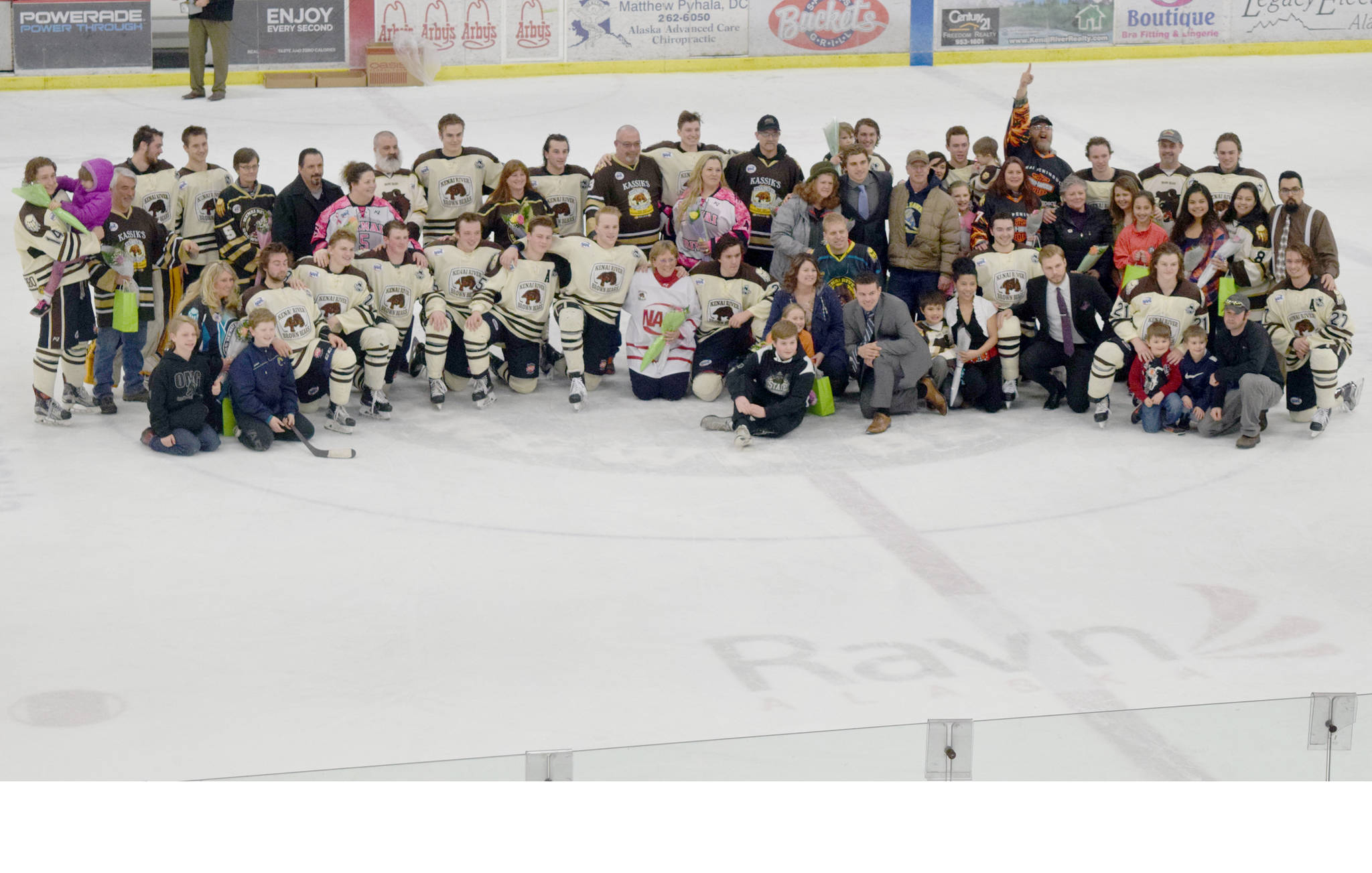 Brown Bears players and their billet families get together for a picture between the first and second periods Friday, March 24, 2017, at the Soldotna Regional Sports Complex. (Photo by Jeff Helminiak/Peninsula Clarion)